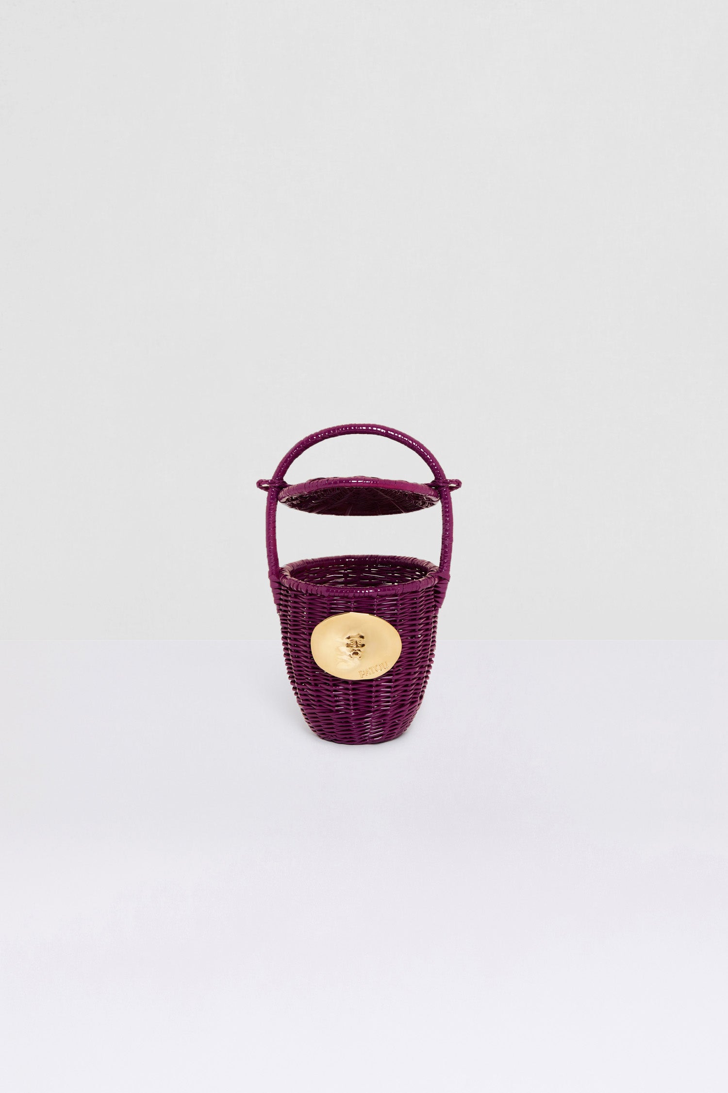 Patou - Wicker bucket bag - Anemone - A design that is oh-so-Patou in a precious new hue.Anemone purple wicker bucket bag. Top handle with a sliding lid. Gold-tone embellishment inspired by the "Bocca della Verità".This bag is handmade and may have some irregularities.