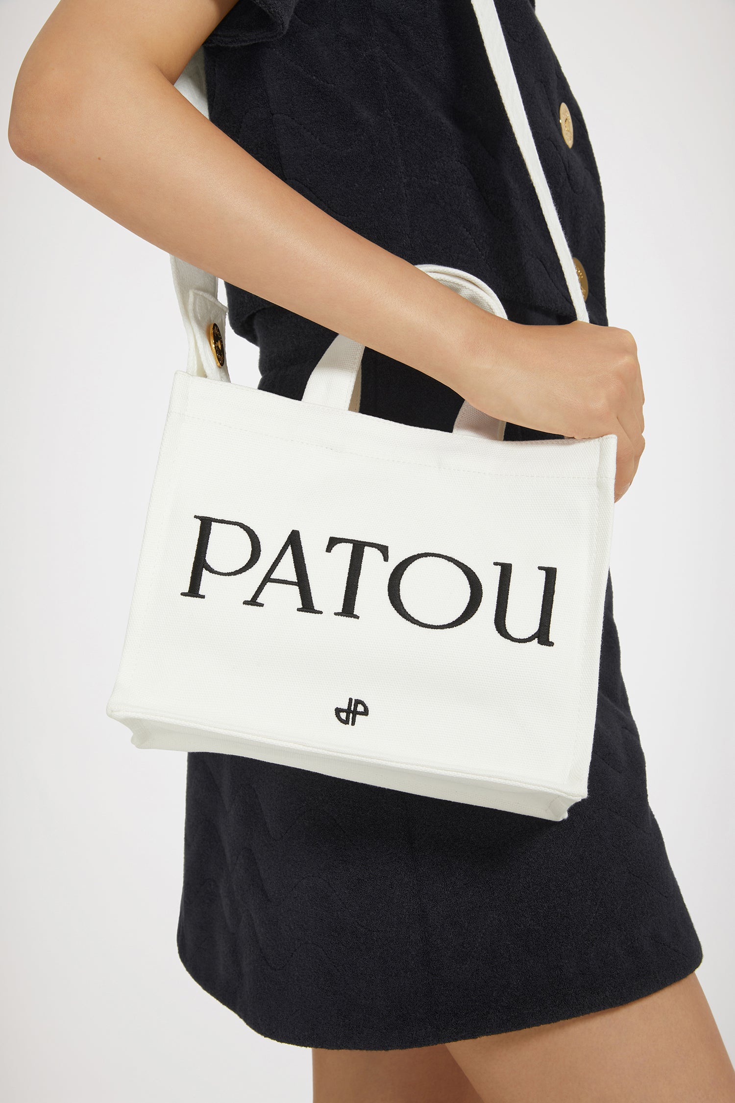 Patou - Small Patou canvas tote in organic cotton - Cream - A little Patou goes a long way.Cream organic cotton tote. Patou lettering logo and JP monogram in black. White embossed shoulder strap with gold buttons. Two top handles. Can be carried by hand or on the shoulder.