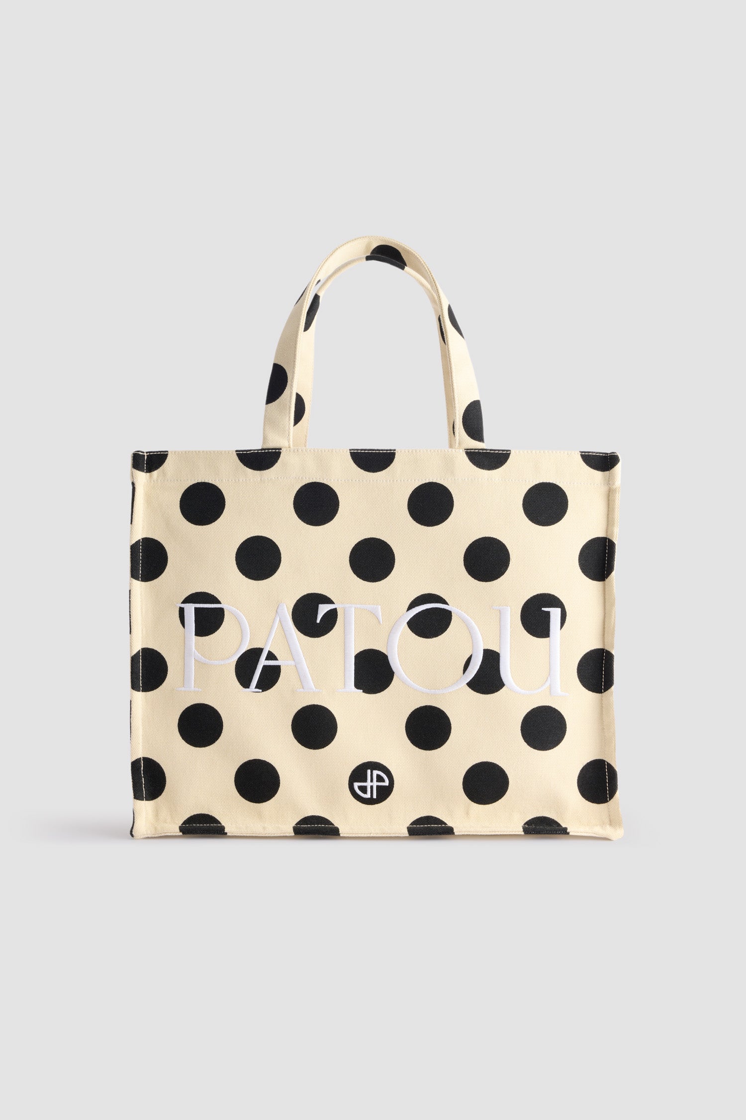 Patou - Large JP tote in printed cotton canvas - Angora Dots - Angora off-white cotton canvas tote. Polka dot pattern. Large version. Embroidered Patou and JP. Embossed shoulder strap with gold buttons. Two top handles. Can be carried by hand or on the shoulder.