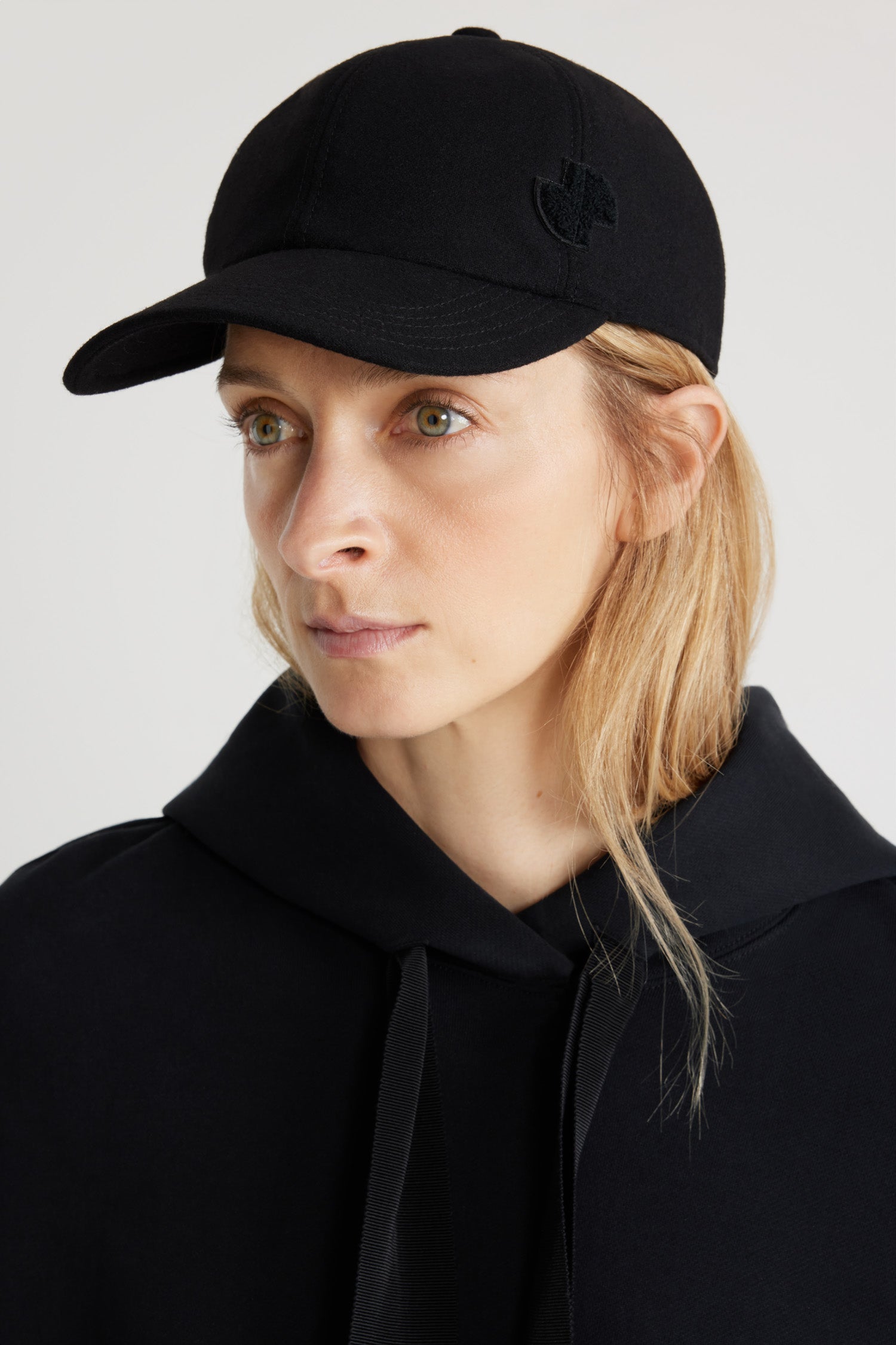 Patou - JP cap in sustainable wool blend - Black - Black sustainable wool blend baseball hat. JP bouclette patch at the side. Elasticated strap at the back. Unisex style.Sizing:S: 55 cm circumferenceM: 57 cm circumferenceL: 59 cm circumference