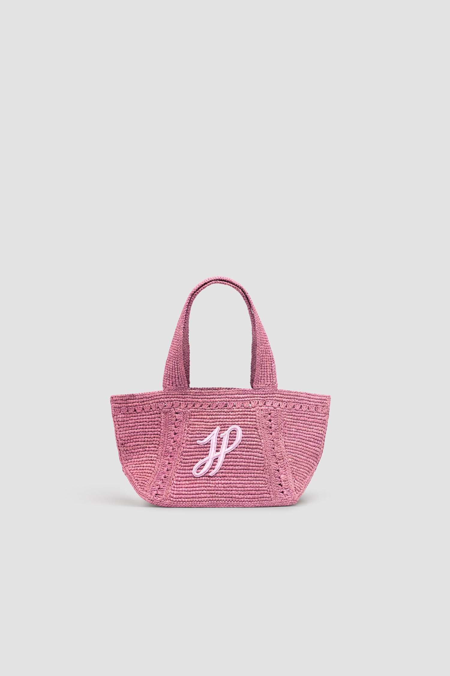 Patou - Small JP monogram trapeze tote in raffia - Primrose Pink - Primrose Pink raffia tote. Small version. Trapeze shape. Two shoulder straps. Tonal JP monogram embroidery at the front.This style was lovingly handcrafted by one of the artisans trained at the Ecole des Savoir Faire.