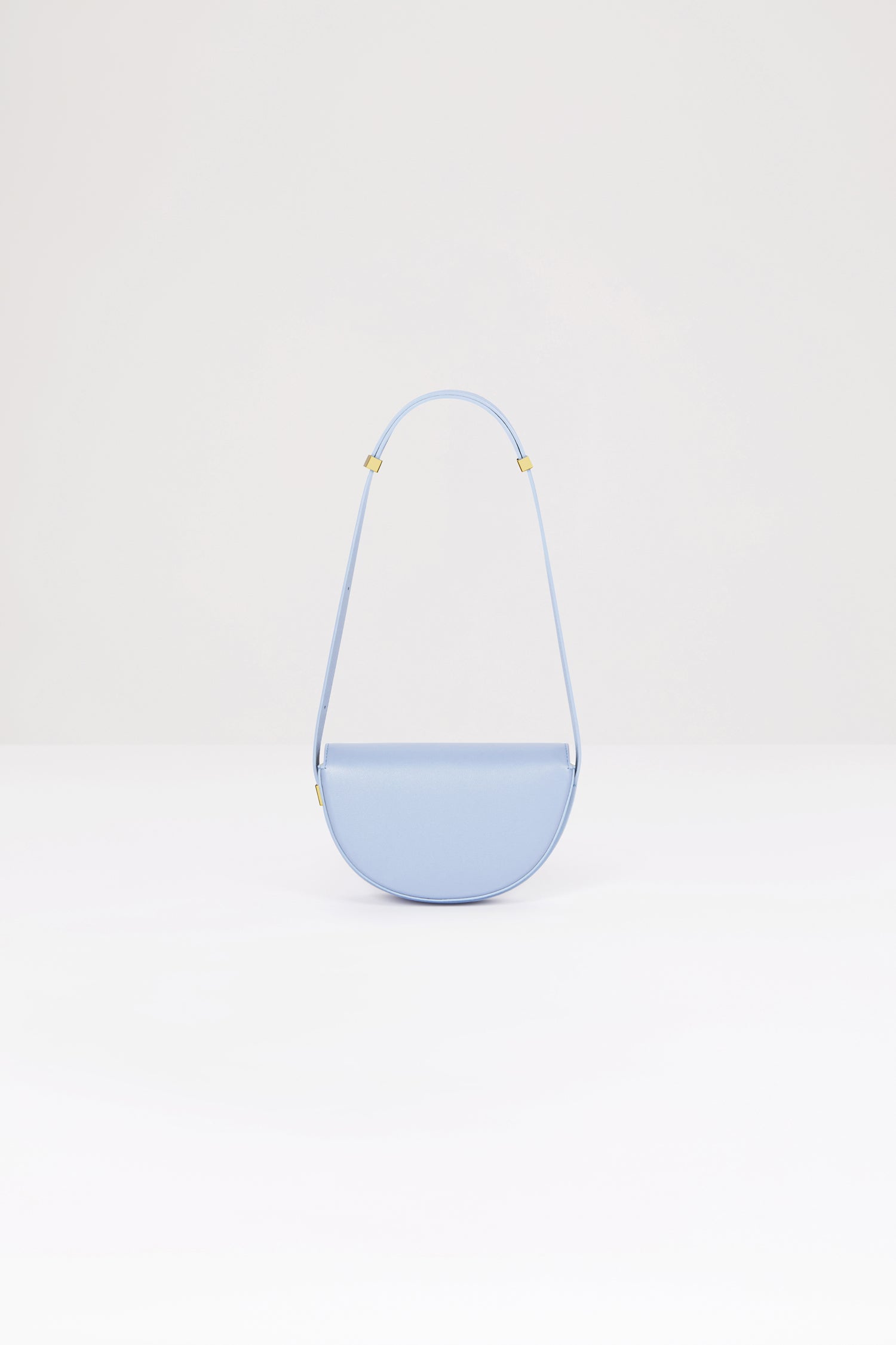 Patou - Le Petit Patou bag in leather - Alaska Blue - A smaller take on everyone's favourite piece of Patou!Alaska Blue leather handbag. Crafted using unique materials sourced from unused high-quality leather hides. 120 limited numbered edition. Half-circle shape with geometric cut-outs inspired by the JP monogram. Gold-tone hardware with Patou-engraved detail at the side. Adjustable strap that allows it to be worn on the shoulder, across the body or carried by hand. Magnetic closure with gold-tone JP detail. Internal compartment. Eco lining.Measures: 20cm (length), 13cm (height), 5cm (depth)