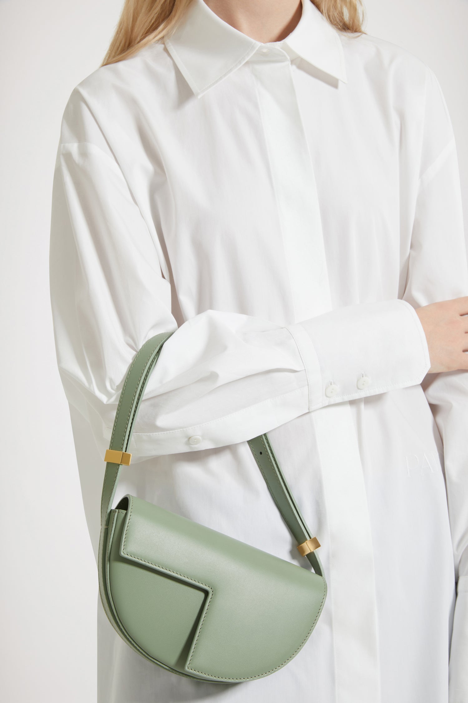 Patou - Le Petit Patou bag in leather - Dark Almond - A smaller take on everyone's favourite piece of Patou!Dark Almond green leather handbag. Crafted using unique materials sourced from unused high-quality leather hides. 80 limited numbered edition. Half-circle shape with geometric cut-outs inspired by the JP monogram. Gold-tone hardware with Patou-engraved detail at the side. Adjustable strap that allows it to be worn on the shoulder, across the body or carried by hand. Magnetic closure with gold-tone JP detail. Internal compartment. Eco lining.Measures: 20cm (length), 13cm (height), 5cm (depth)
