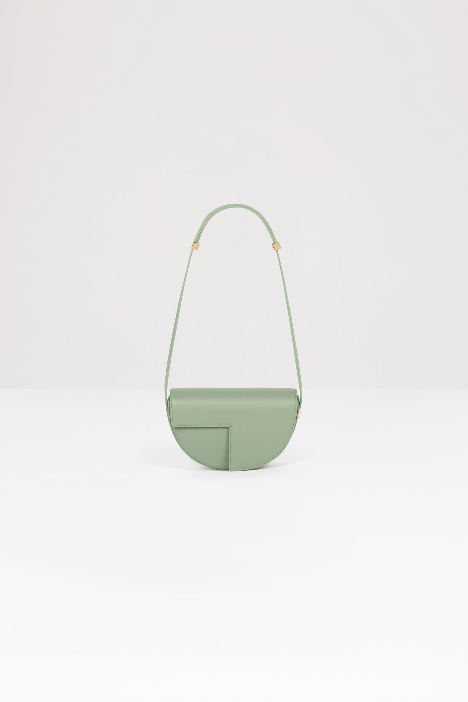 Patou - Le Petit Patou bag in leather - Dark Almond - A smaller take on everyone's favourite piece of Patou!Dark Almond green leather handbag. Crafted using unique materials sourced from unused high-quality leather hides. 80 limited numbered edition. Half-circle shape with geometric cut-outs inspired by the JP monogram. Gold-tone hardware with Patou-engraved detail at the side. Adjustable strap that allows it to be worn on the shoulder, across the body or carried by hand. Magnetic closure with gold-tone JP detail. Internal compartment. Eco lining.Measures: 20cm (length), 13cm (height), 5cm (depth)
