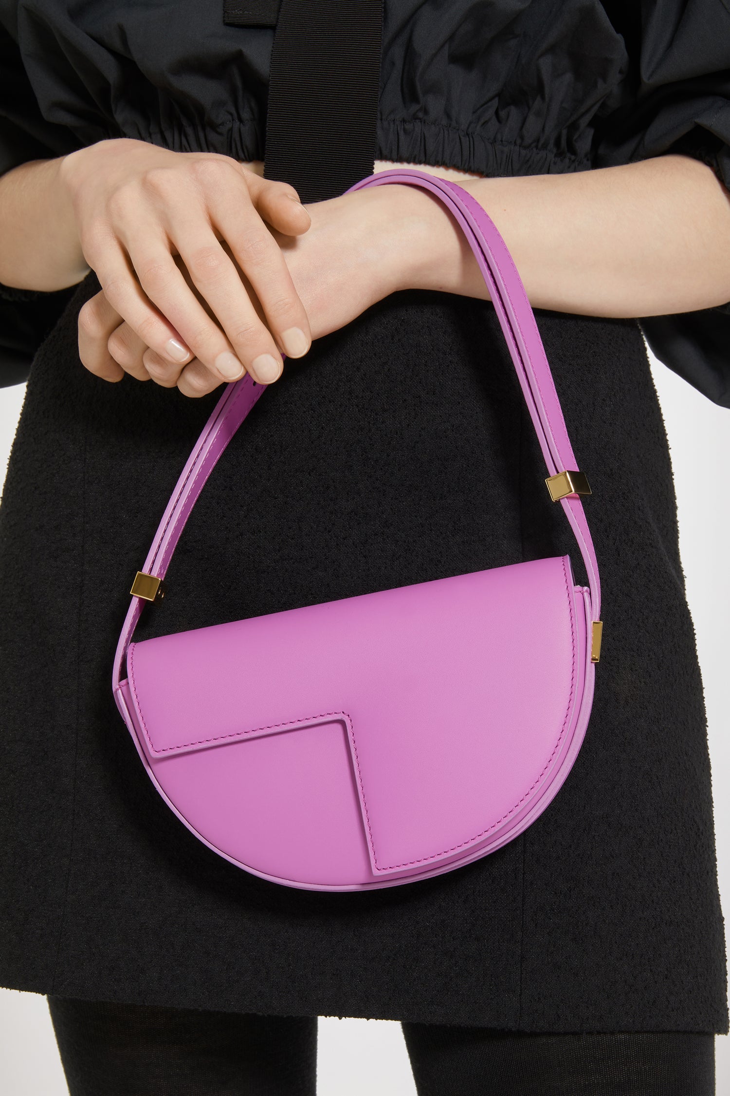 Patou - Le Petit Patou bag in leather - Amethyst - A smaller take on everyone's favourite piece of Patou!Amethyst purple leather handbag. Crafted using unique materials sourced from unused high-quality leather hides. 80 limited numbered edition. Half-circle shape with geometric cut-outs inspired by the JP monogram. Gold-tone hardware with Patou-engraved detail at the side. Adjustable strap that allows it to be worn on the shoulder, across the body or carried by hand. Magnetic closure with gold-tone JP detail. Internal compartment. Eco lining.Measures: 20cm (length), 13cm (height), 5cm (depth)