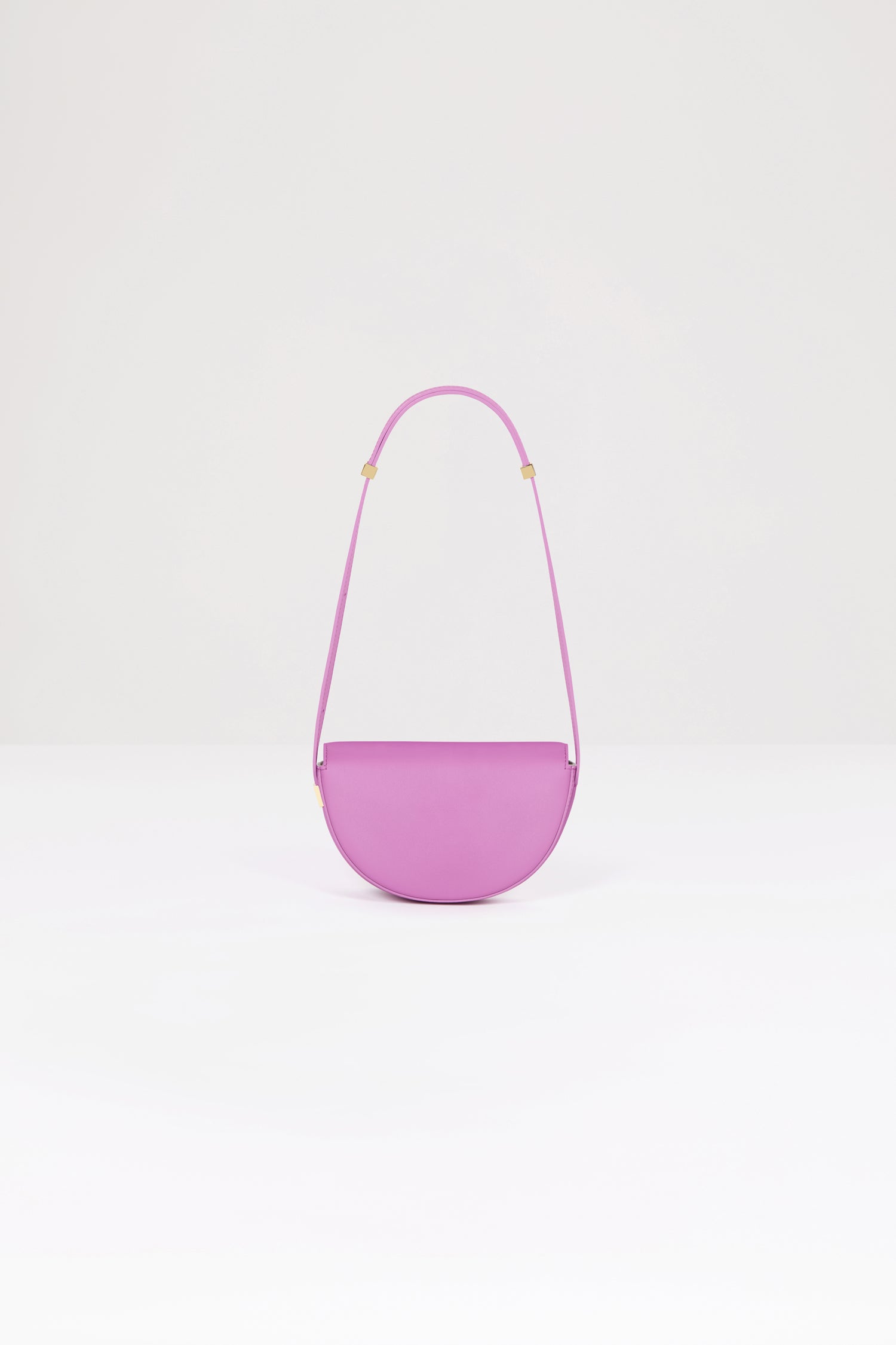 Patou - Le Petit Patou bag in leather - Amethyst - A smaller take on everyone's favourite piece of Patou!Amethyst purple leather handbag. Crafted using unique materials sourced from unused high-quality leather hides. 80 limited numbered edition. Half-circle shape with geometric cut-outs inspired by the JP monogram. Gold-tone hardware with Patou-engraved detail at the side. Adjustable strap that allows it to be worn on the shoulder, across the body or carried by hand. Magnetic closure with gold-tone JP detail. Internal compartment. Eco lining.Measures: 20cm (length), 13cm (height), 5cm (depth)