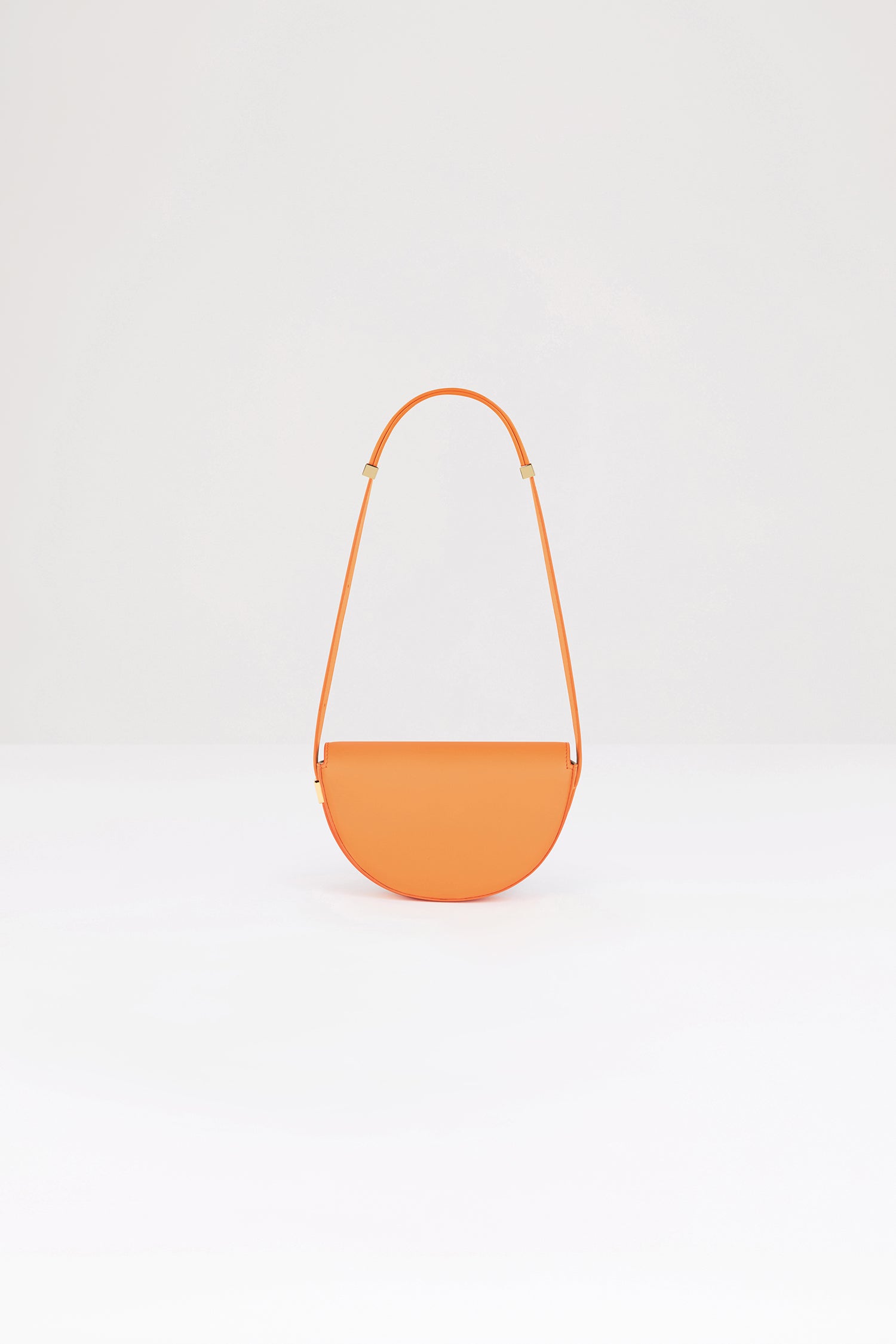 Patou - Le Petit Patou bag in leather - Bright Orange - A smaller take on everyone's favourite piece of Patou!Bright orange leather handbag. Crafted using unique materials sourced from unused high-quality leather hides. 80 limited numbered edition. Half-circle shape with geometric cut-outs inspired by the JP monogram. Gold-tone hardware with Patou-engraved detail at the side. Adjustable strap that allows it to be worn on the shoulder, across the body or carried by hand. Magnetic closure with gold-tone JP detail. Internal compartment. Eco lining.Measures: 20 cm (length), 13 cm (height), 5 cm (depth)