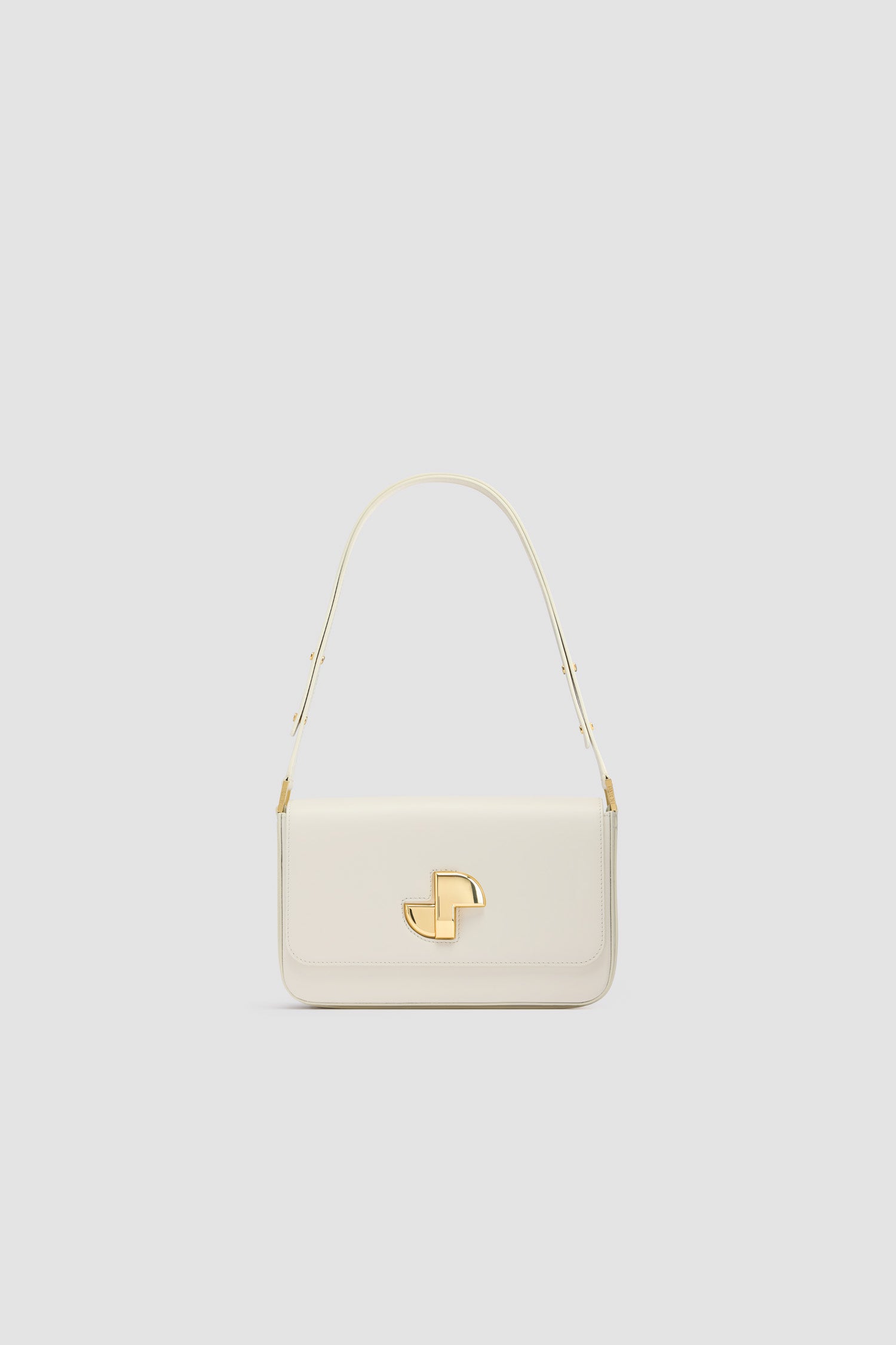Patou - レザー Le Classic Lock バッグ - Angora - アンゴラオフホワイトのレザー製ハンドバッグ。ひねりを効かせた、クラシックなデイバッグ。フロントにゴールドのアールデコ調JPツイストクラスプ。肩掛けまたは手持ちのどちらでも持ち運べる調節可能なストラップ付き。レザーライニング。