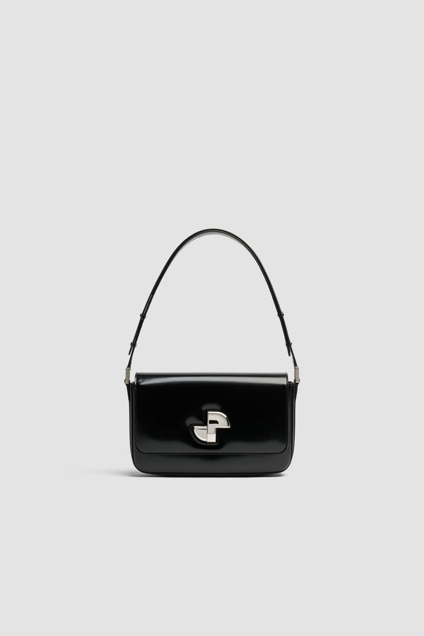 Patou - Sac Le Classic Lock en cuir - Black - Sac à main en cuir brillant noir. Sac de jour classique revisité. Fermoir rotatif JP doré d’inspiration Art Déco sur le devant. Bandoulière réglable pouvant être portée courte ou longue. Doublure en cuir.