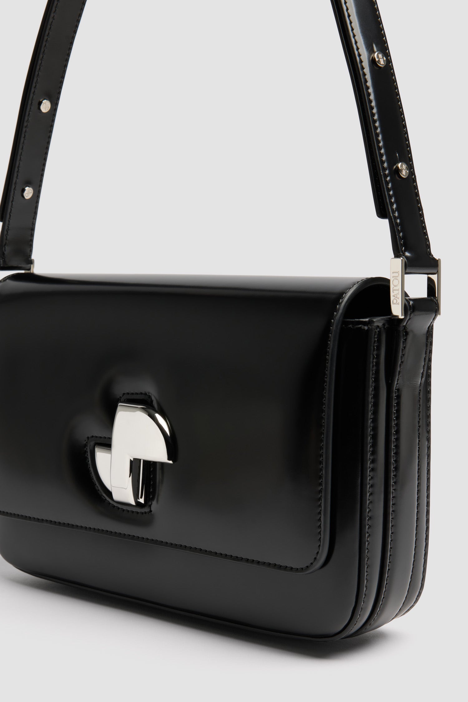 Patou - Le Classic Lock レザーバッグ - Black - ブラックのつややかなレザー製ハンドバッグ。ひねりを効かせた、クラシックなデイバッグ。フロントにゴールドのアールデコ調JPツイストクラスプ。肩掛けまたは手持ちのどちらでも持ち運べる調節可能なストラップ付き。レザーライニング。