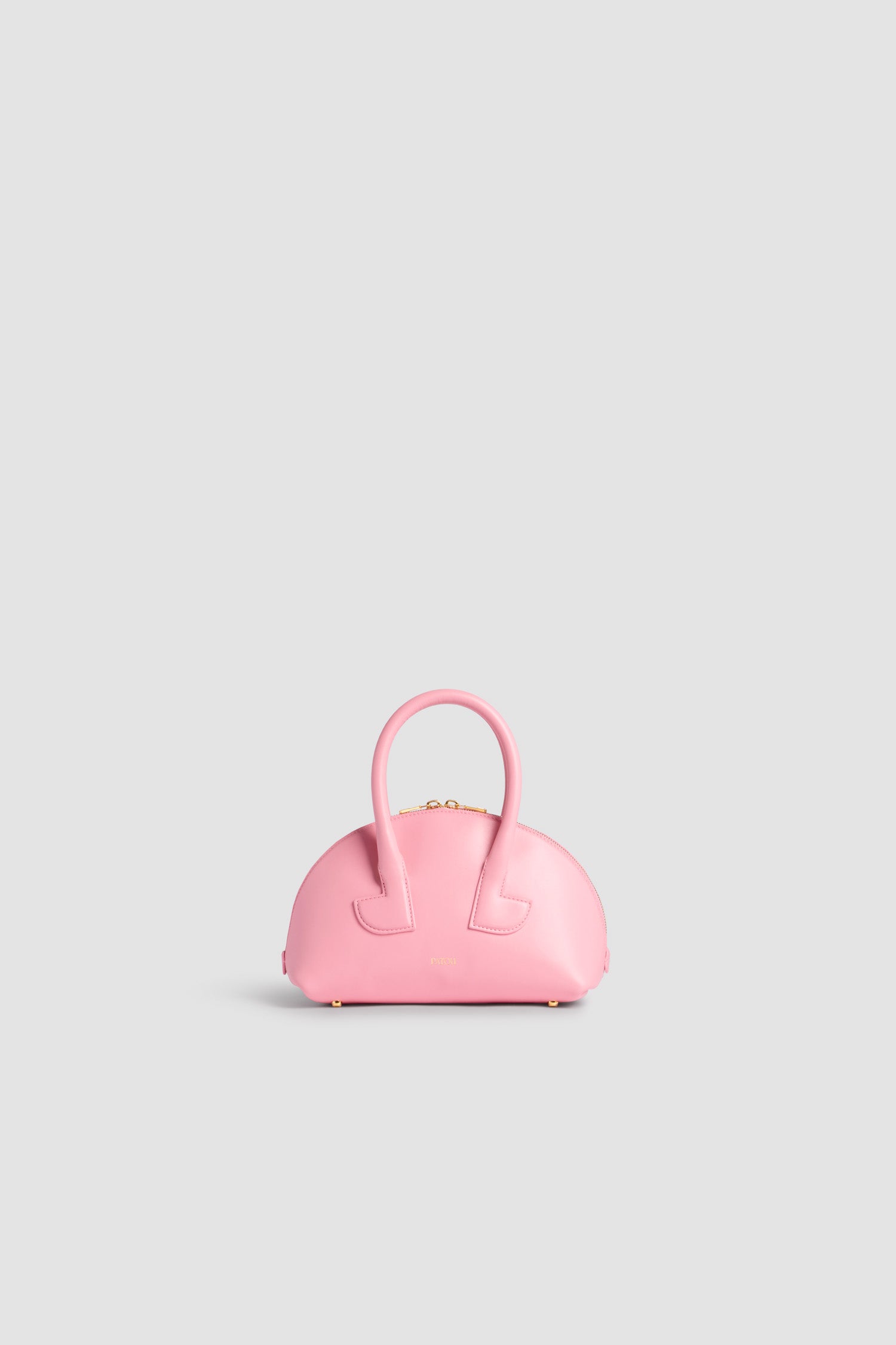 Patou - Le Patou Bowling bag in leather - Primrose Pink - Primrose Pink smooth leather handbag. Bowling shape. Two top handles with geometric cut-out details. Removable shoulder strap. Two-way gold-tone top zip fastening. Gold-embossed Patou logo at the front. Gold-tone metal feet.