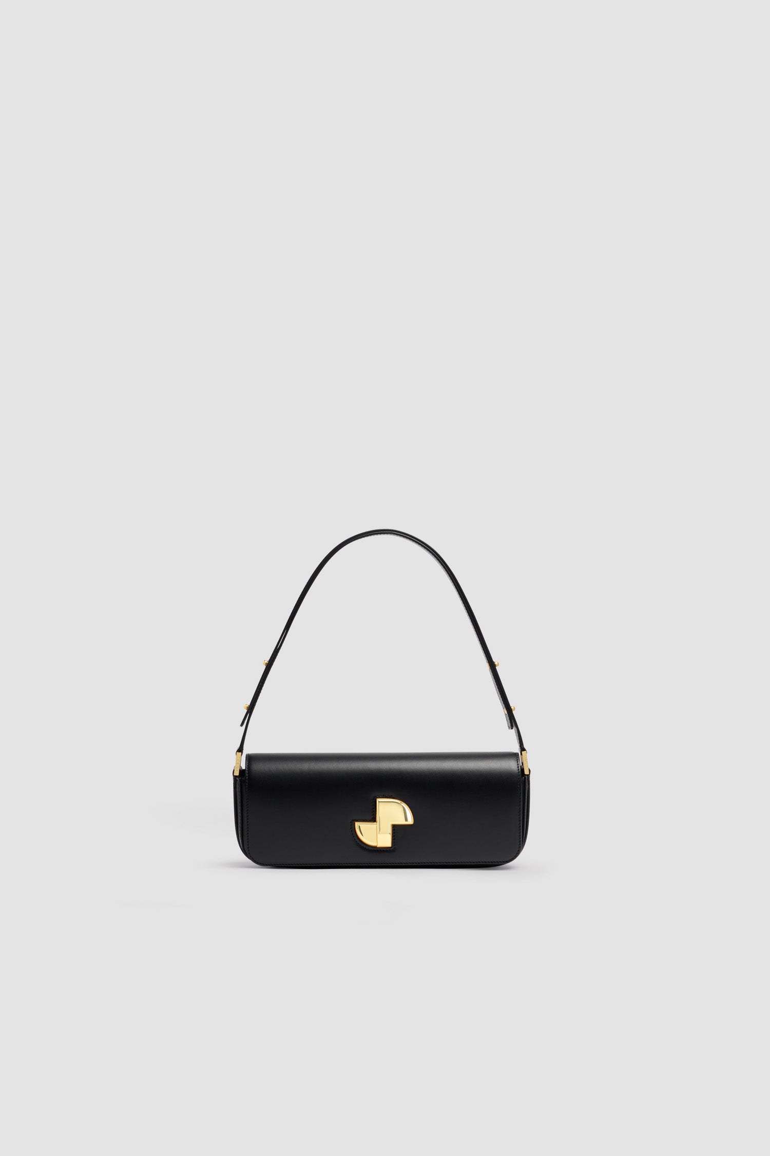 Patou - Le Lock レザー バゲットバッグ - Black - ブラックのスムースレザー製ハンドバッグ。長めシェイプのクラシックなデイバッグ。フロントにゴールドのアールデコ調JPツイストクラスプ。肩掛けまたは手持ちのどちらでも持ち運べる調節可能なストラップ付き。レザーライニング。