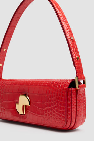 Le Lock Baguette bag in crocodile-embossed leather