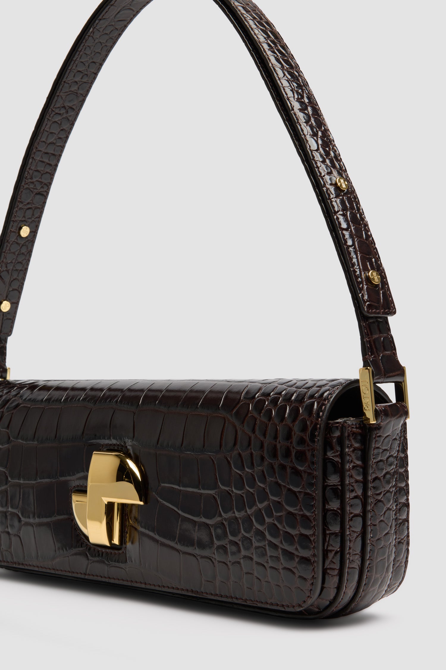 Patou - Borsa Le Lock Baguette in pelle di coccodrillo goffrata - Smoked Ebony - Borsa in pelle di coccodrillo goffrata Smoked Ebony. Borsa da giorno classica rivisitata con una forma allungata. Fermaglio girevole JP oro in stile Art Déco sul davanti. Tracolla regolabile che può essere indossata lunga o corta. Fodera in pelle.