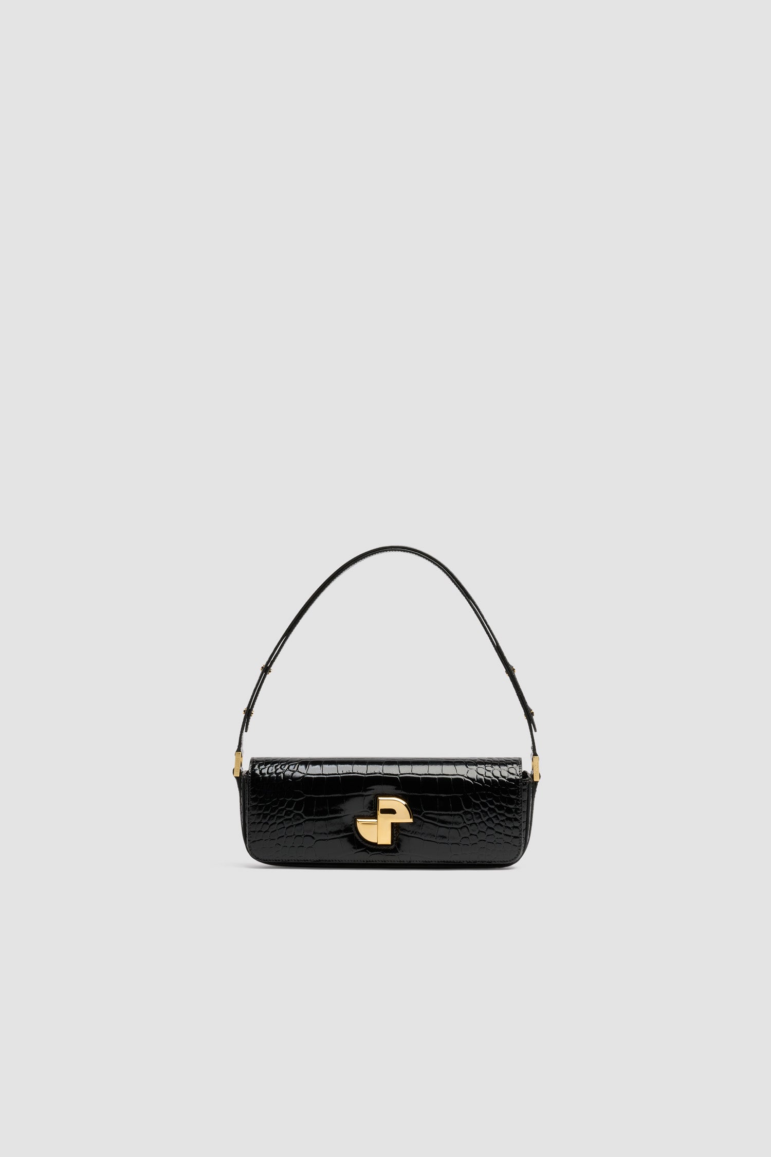 Patou - Le Lock Baguette bag in crocodile-embossed leather - Black - Black crocodile-embossed leather handbag. Classic day bag inspiration with an elongated shape. Gold Art Deco JP twist clasp at the front. Adjustable strap that allows it to be worn short or long. Leather lining.