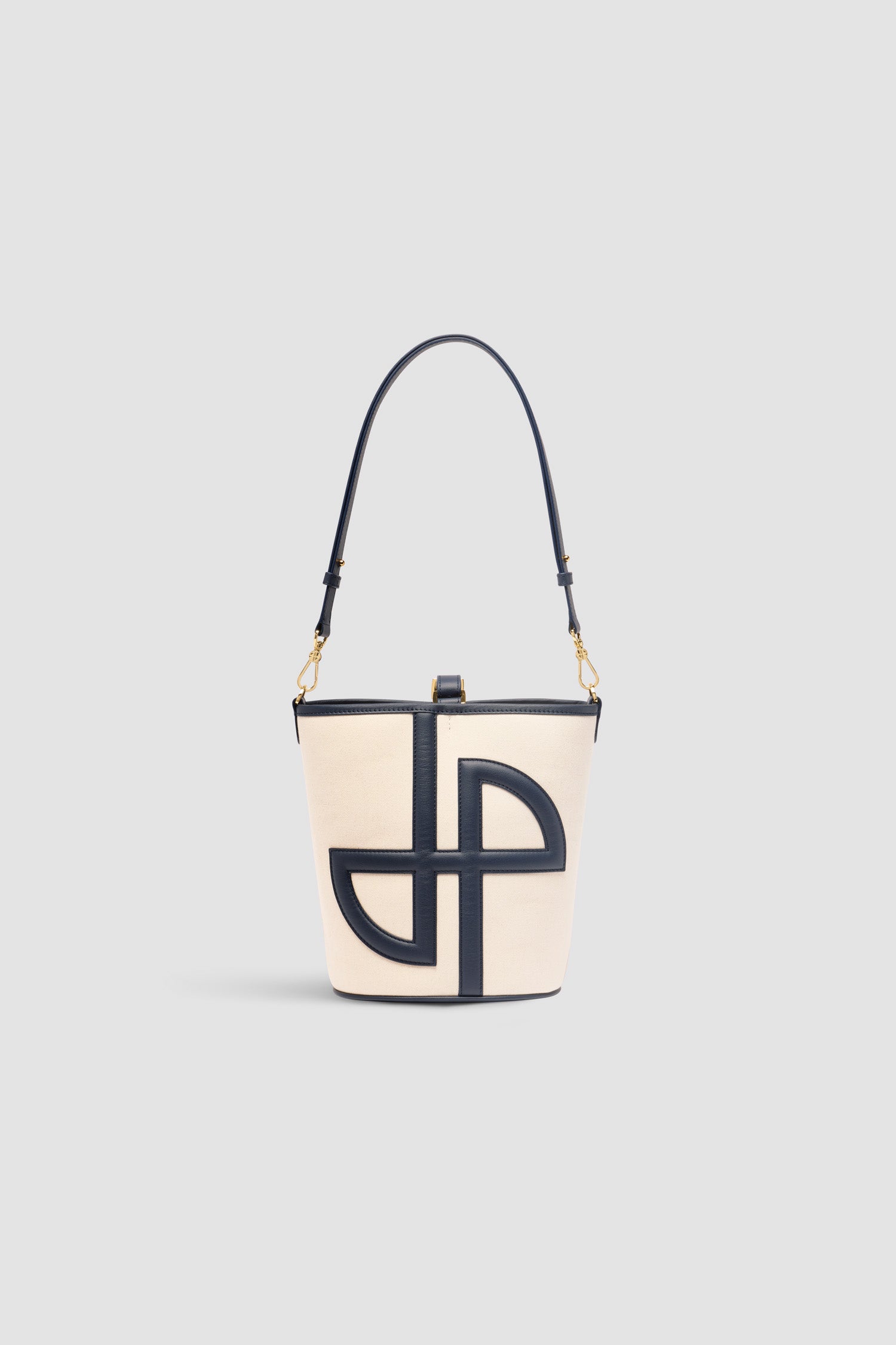 Patou - Borsa a secchiello JP media in pelle e cotone - Navy Black - Borsa in pelle blu nero e cotone naturale. Realizzata con pellami recuperati dal ciclo di produzione. Modello medio. Forma a secchiello con monogramma JP in 3D sul davanti. Chiusura con cinghia. Tracolla rimovibile e regolabile. Parti metalliche oro. Piedini in metallo. Logo Patou oro sulla base.