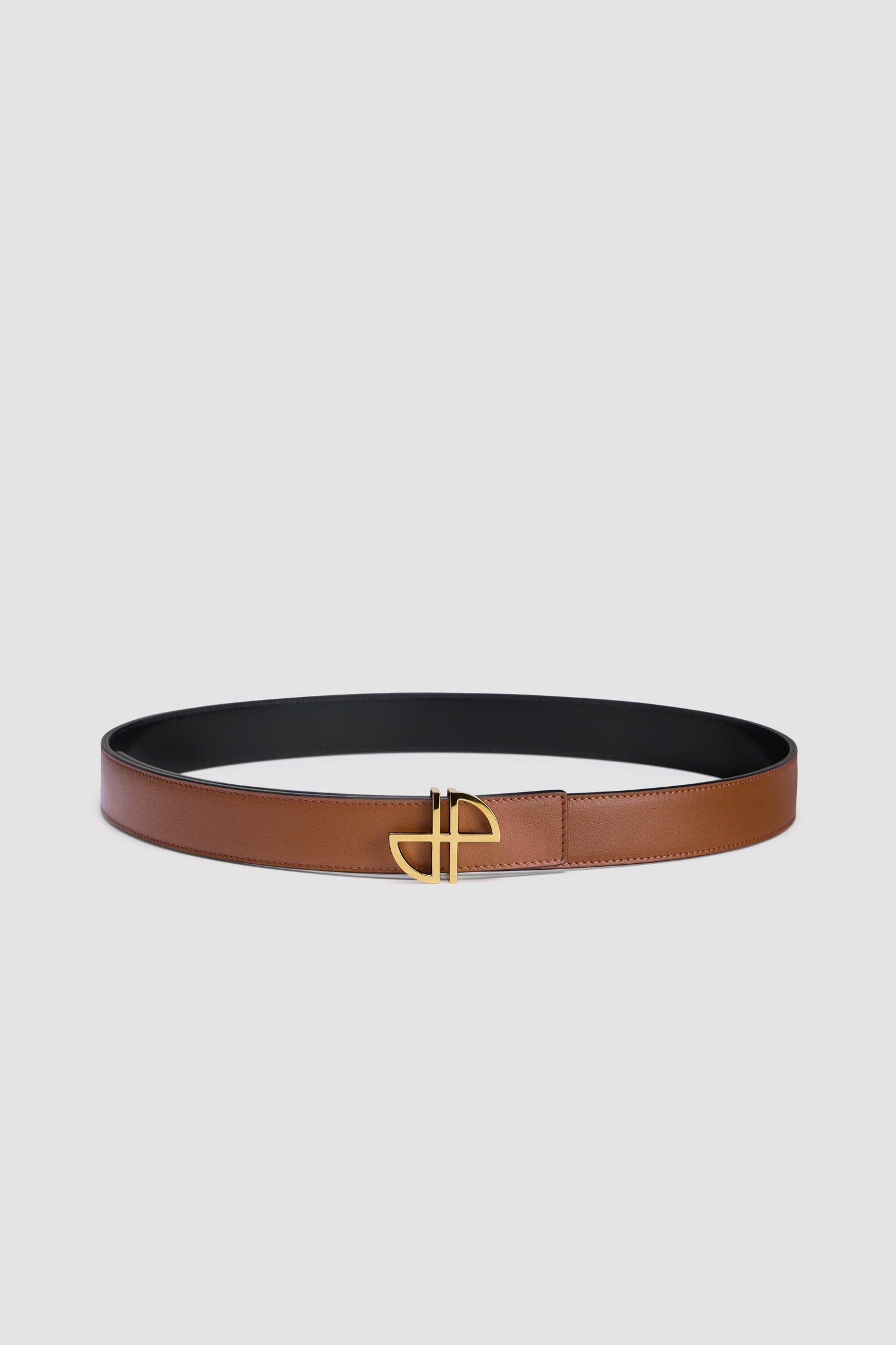 Patou - Cintura JP in pelle - Black Chestnut - Cintura in pelle nera e marrone castagna. Fibbia JP oro. Modello regolabile e reversibile. Chiusura a borchio.Taglia S (lunghezza massima): 85 cmTaglia M (lunghezza massima): 90 cmTaglia L (lunghezza massima): 100 cm