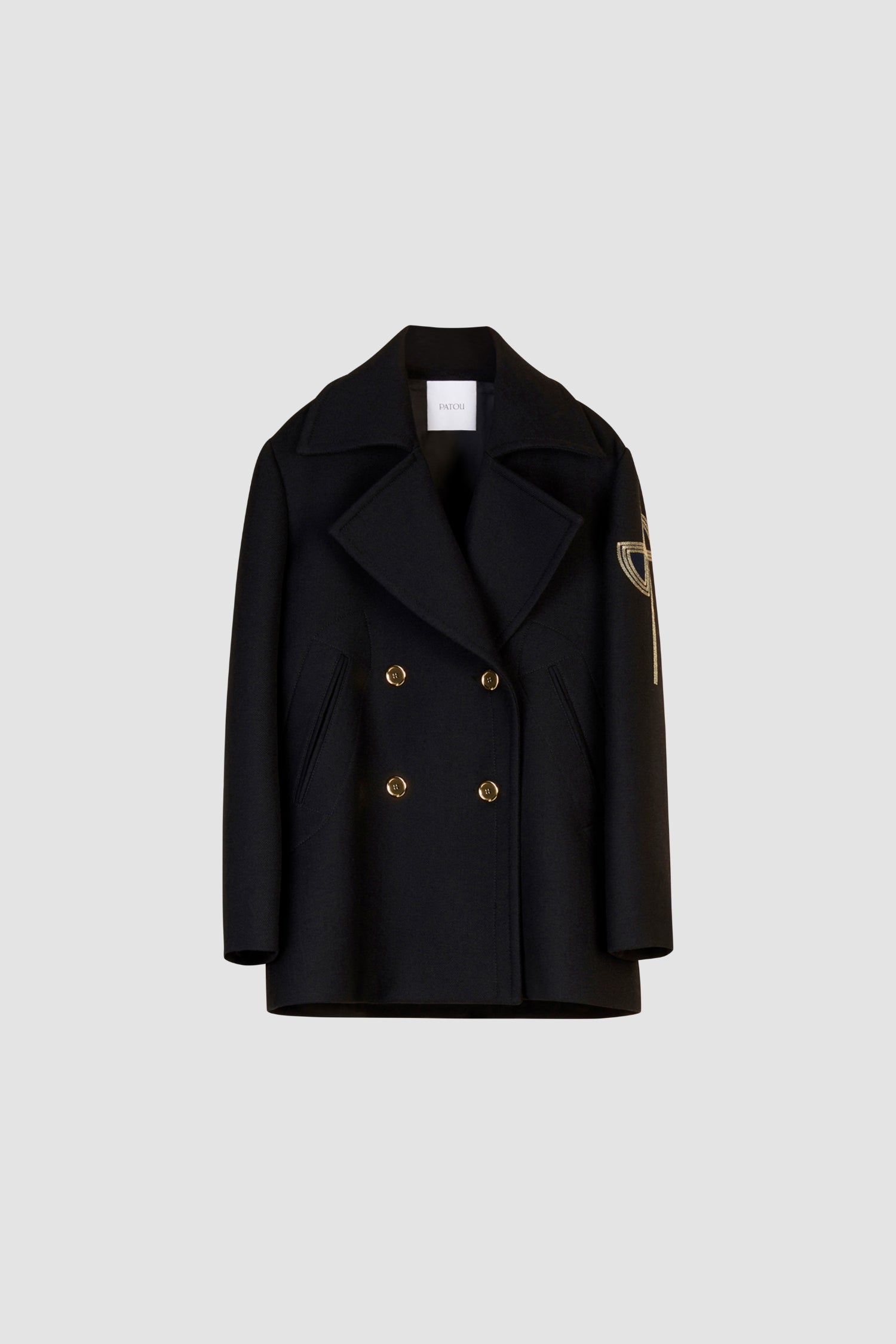 Patou - Oversized wool peacoat with embroidered logo - Black - Gold accents stand out against navy wool.Black virgin wool peacoat. Double-breasted style with exaggerated lapels. Engraved gold-coloured buttons and gold embroidered logo on the sleeve. Slit pockets at the sides. Fully lined.