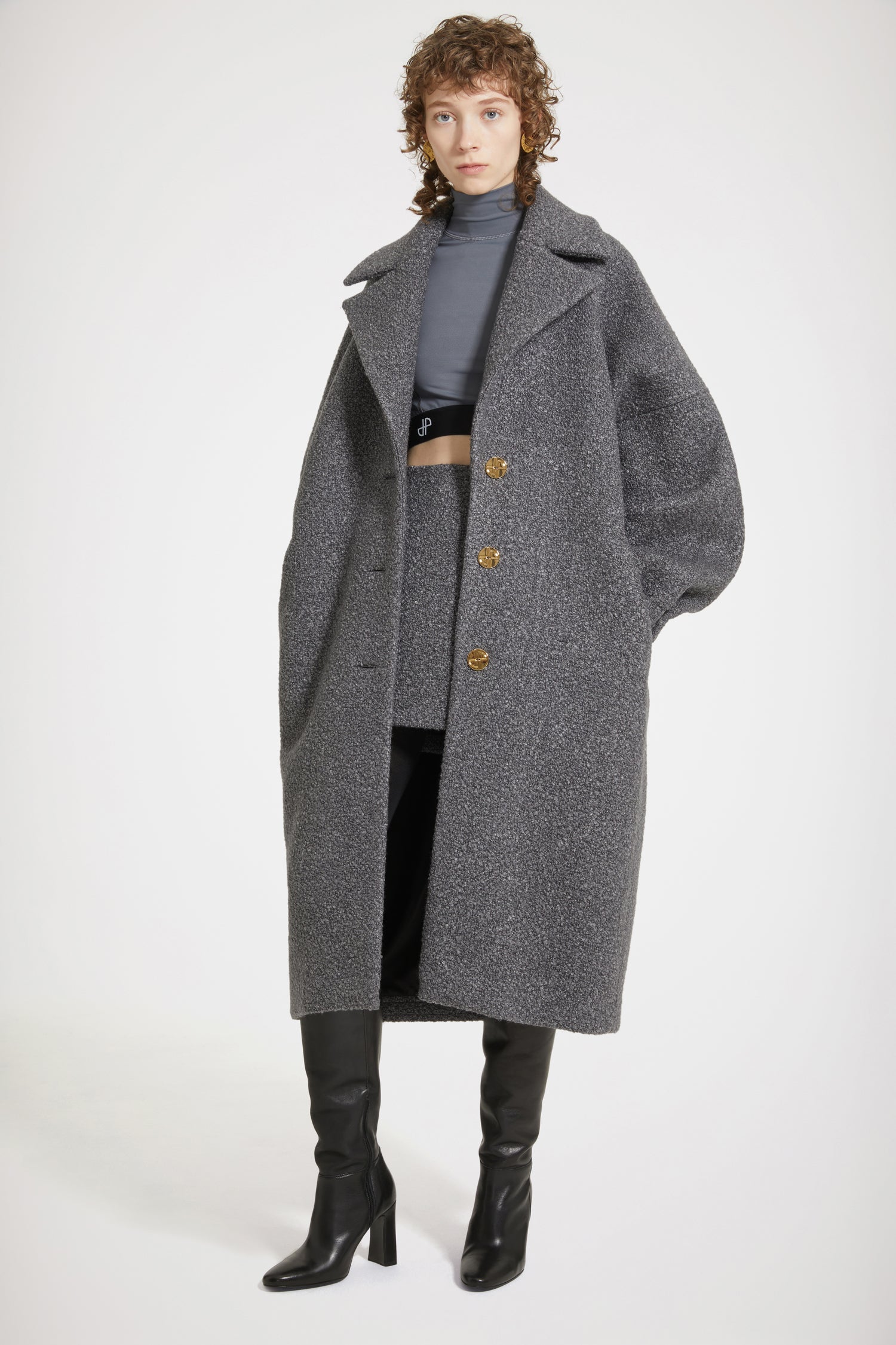 Patou - Cocoon coat in wool-blend bouclé - Anthracite - The soft embrace of a Patou coat.Anthracite grey wool-blend coat. Mélange bouclé fabric. Soft cocoon silhouette. Notch lapels. Art Deco-style gold-tone JP-engraved buttons. Volume sleeves. Elasticated cuffs. Pockets at the sides. Fully lined.Voluminous coat with long sleeves.