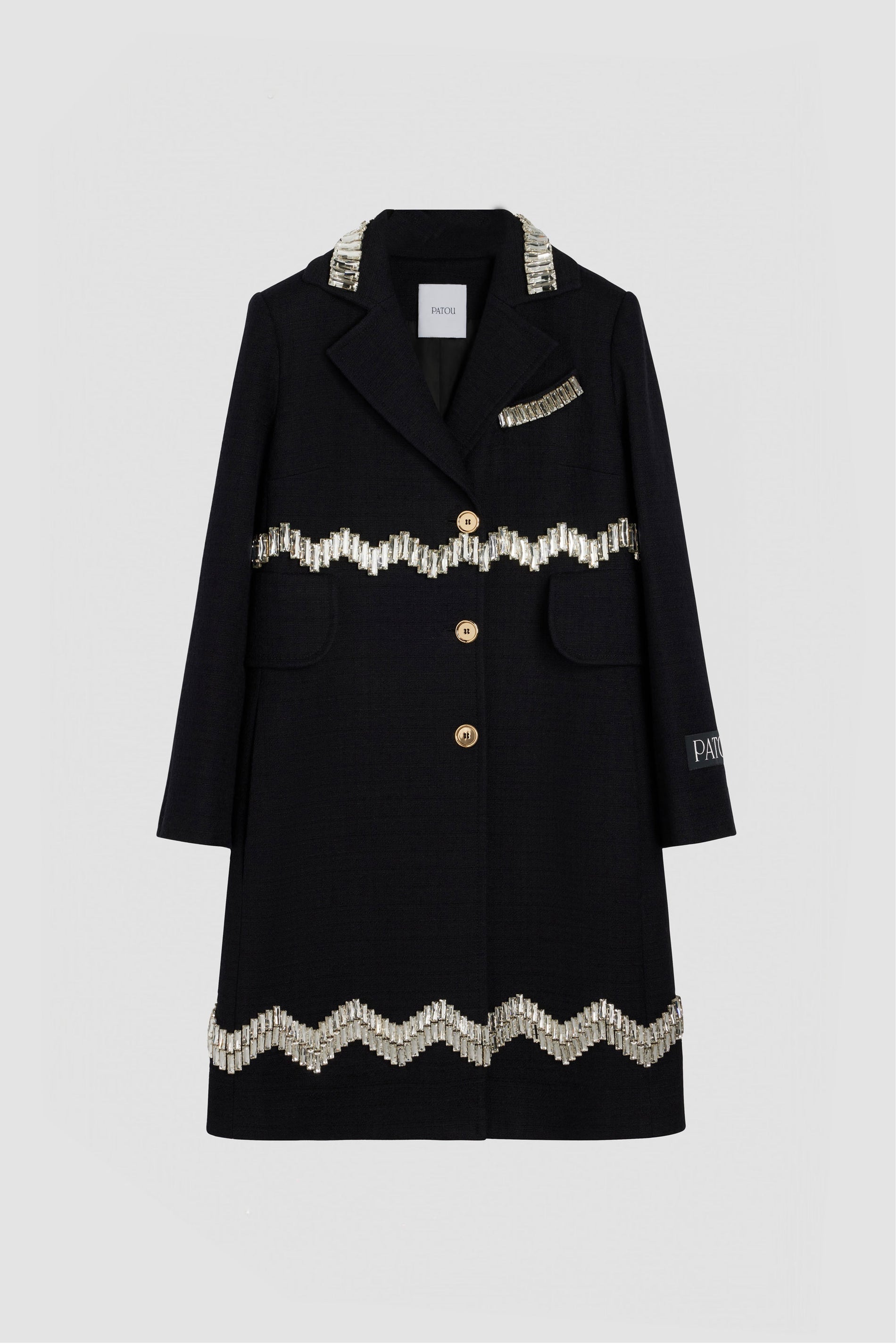 Patou - Embellished summer coat in cotton tweed - Black - The perfect summer layer.Black cotton tweed coat. Mid length. A-line silhouette. Single-breasted style with off-center placket. Crystal bead embellishments. Notch lapels. Mock chest pocket. High flap pockets. Gold-tone Patou-engraved buttons. Cropped sleeves. Patou label on the left sleeve.This style is very fitted. We suggest ordering one size up or wearing it over skintight layers.