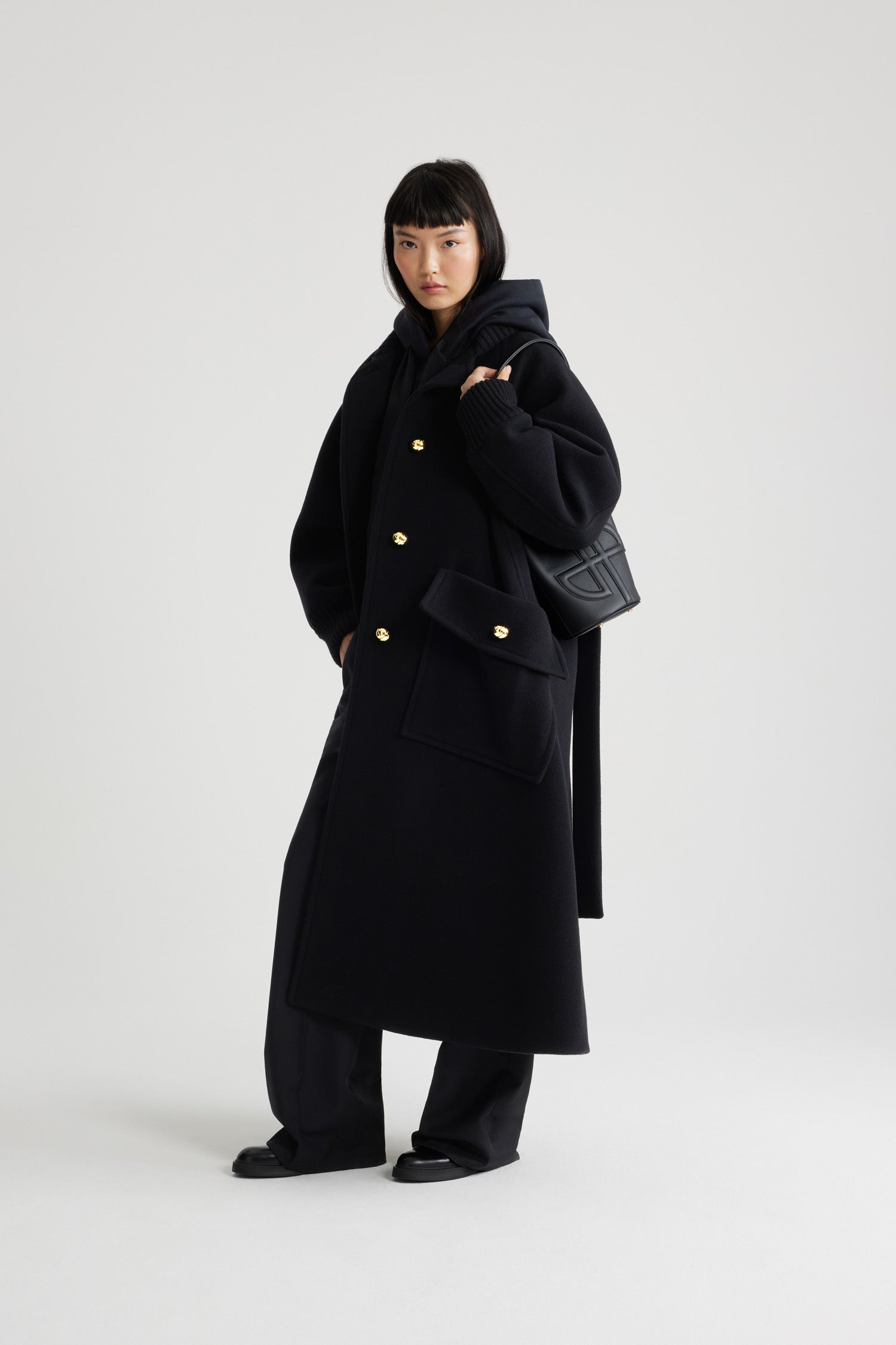 Patou - Oversized coat in wool and cashmere blend - Black - Black wool and cashmere blend coat. Oversized fit. Long length. A-line silhouette. Rib knit collar and cuffs. Raglan sleeves. Gold-tone half-sphere JP buttons. Self-tie belt at the waist. Maxi patch pockets with buttoned flap. Box pleat at the back.This style is oversized.