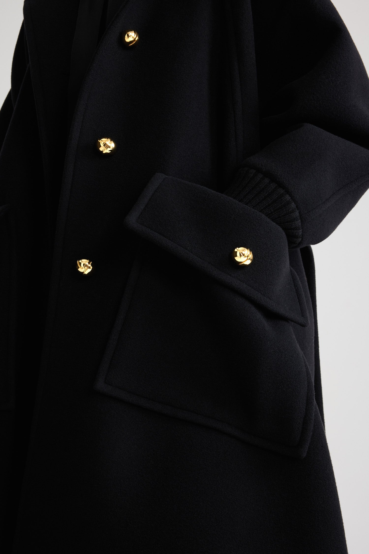 Patou - Oversized coat in wool and cashmere blend - Black - Black wool and cashmere blend coat. Oversized fit. Long length. A-line silhouette. Rib knit collar and cuffs. Raglan sleeves. Gold-tone half-sphere JP buttons. Self-tie belt at the waist. Maxi patch pockets with buttoned flap. Box pleat at the back.This style is oversized.
