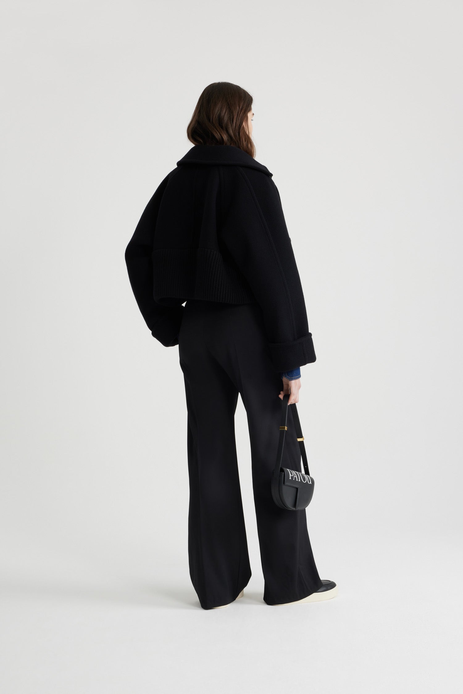 Patou - Cappotto corto con orlo a costine in lana e cachemire - Black - Capotto in misto lana e cachemire ecosostenibile nero. Modello corto. Colletto largo. Maniche raglan. Bottoni JP sferici oro. Orlo a costine largo. Polsini con risvolto.Questo modello è corto e oversize.