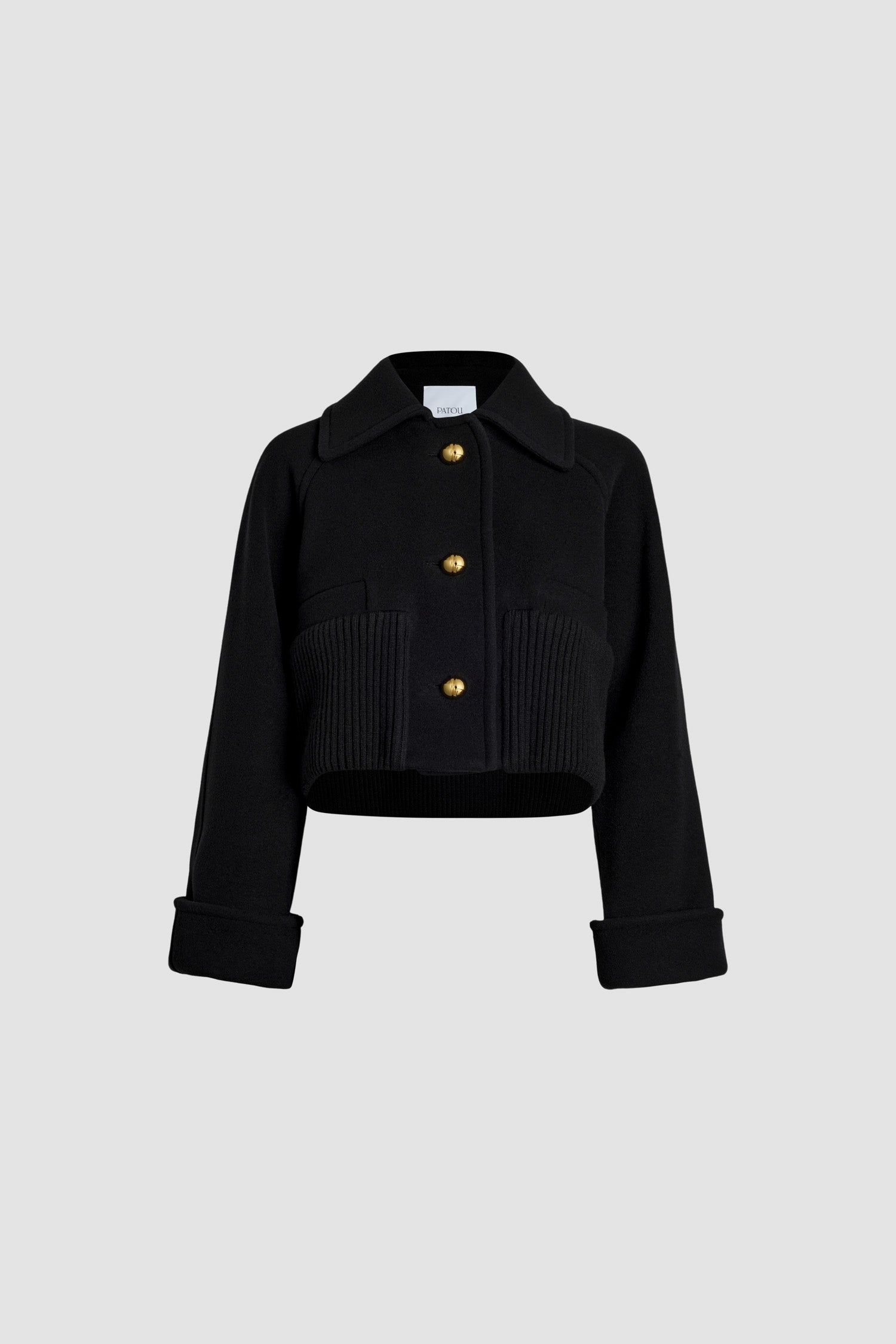 Patou - Cappotto corto con orlo a costine in lana e cachemire - Black - Capotto in misto lana e cachemire ecosostenibile nero. Modello corto. Colletto largo. Maniche raglan. Bottoni JP sferici oro. Orlo a costine largo. Polsini con risvolto.Questo modello è corto e oversize.