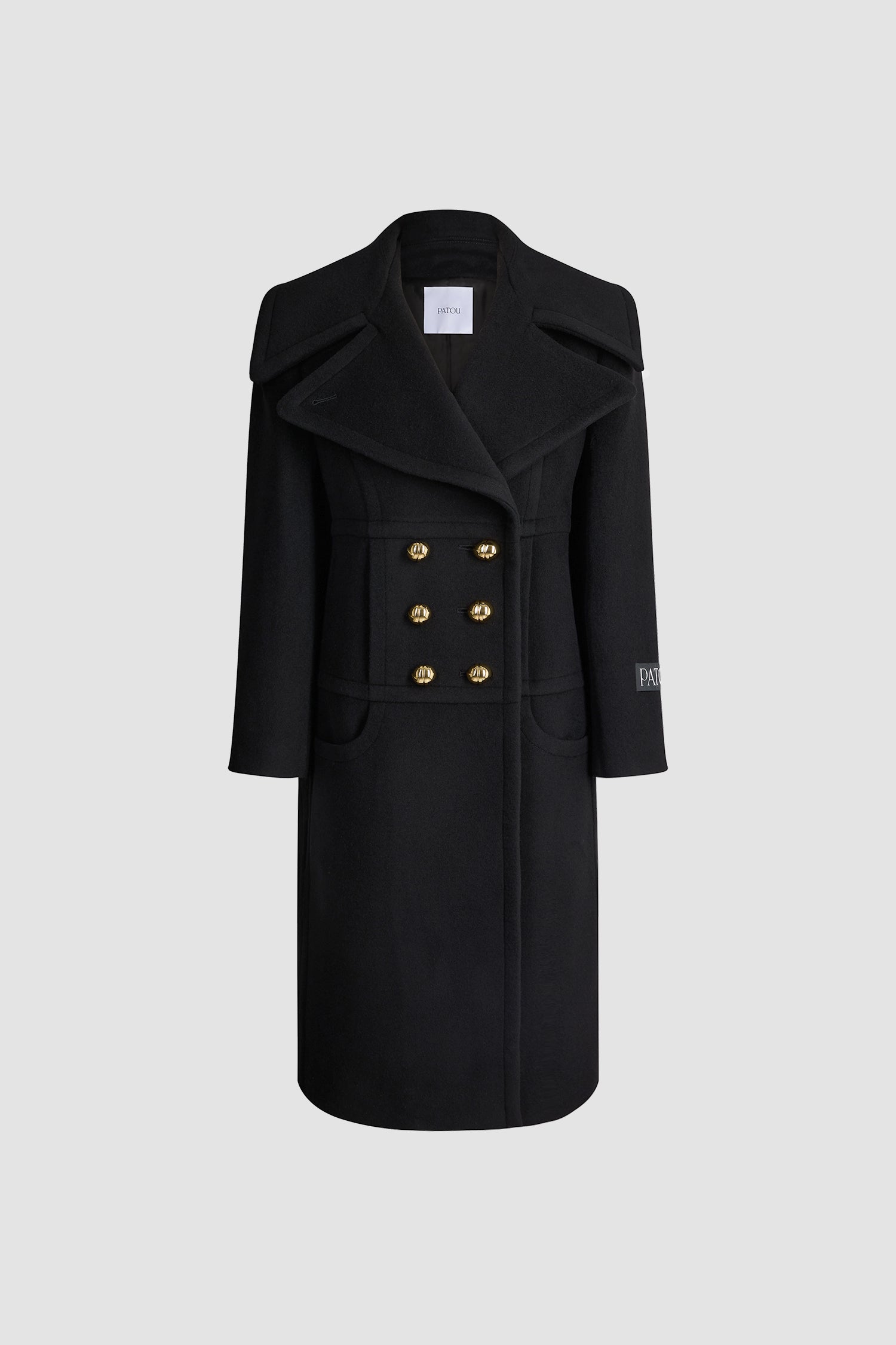 Patou - Manteau croisé en laine mélangée éco-responsable - Black - Manteau en laine mélangée éco-responsable noire. Modèle long. Silhouette droite. Construction à double boutonnage. Revers en pointe larges. Boutons boule dorés à monogramme JP. Coutures arrondies à l’avant. Poches dans les coutures. Étiquette Patou sur la manche gauche. Modèle doublé.
