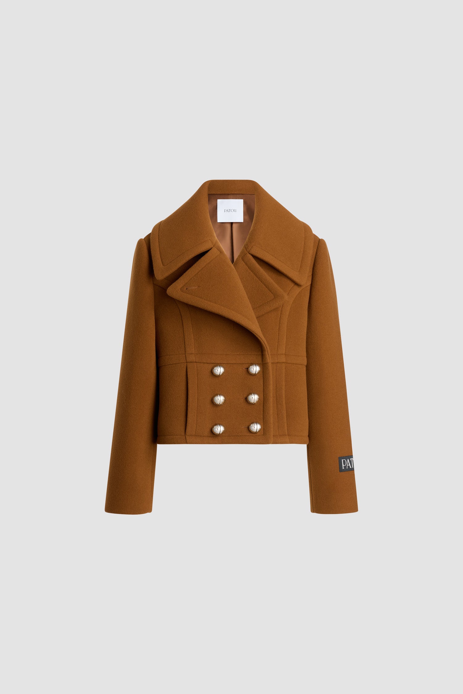 Patou - Cropped double-breasted coat in sustainable wool blend - Mahogany - Mahogany sustainable wool blend coat. Cropped length. Straight silhouette. Double-breasted construction. Wide peak lapel. Silver-tone half-sphere JP monogram buttons. Curved seams at the front. Seam pockets. Patou logo label on the left sleeve. Lined.