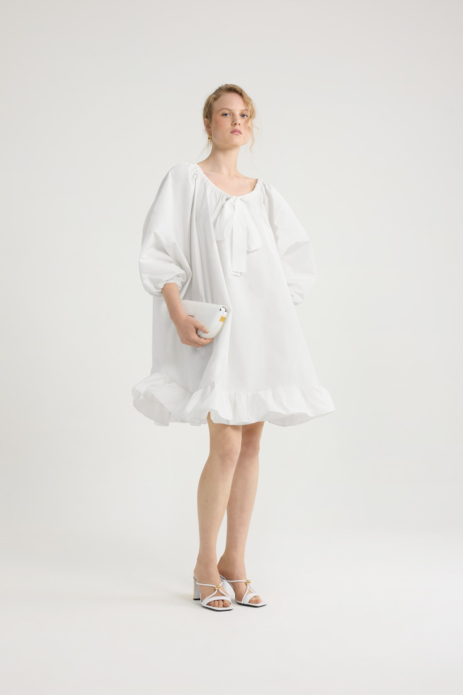 Patou - Ruffle hem dress in recycled faille - White - White recycled polyester faille dress. Knee length. High volume silhouette. Elasticated neckline with grosgrain drawstring that can be worn off the shoulders. Balloon sleeves with elasticated cuffs. Double ruffle at the hem.This dress is part of the Cérémonie capsule collection designed with love for very special occasions.
