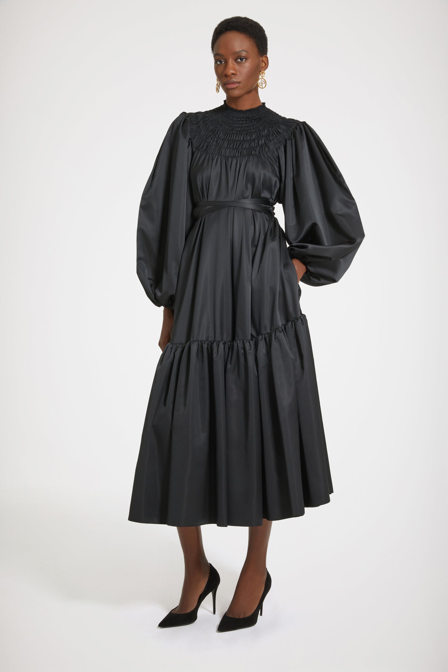 Patou - Smock collar maxi dress in eco-friendly satin - Black - This dress is a total smock show! Black recycled polyester satin dress. Maxi length. High neckline with smocked detailing. Volume sleeves with puff shoulders and elasticated cuffs. Removable belt at the waist that can be tied at the front or back. Tiered skirt.Voluminous dress with puffed sleeves.