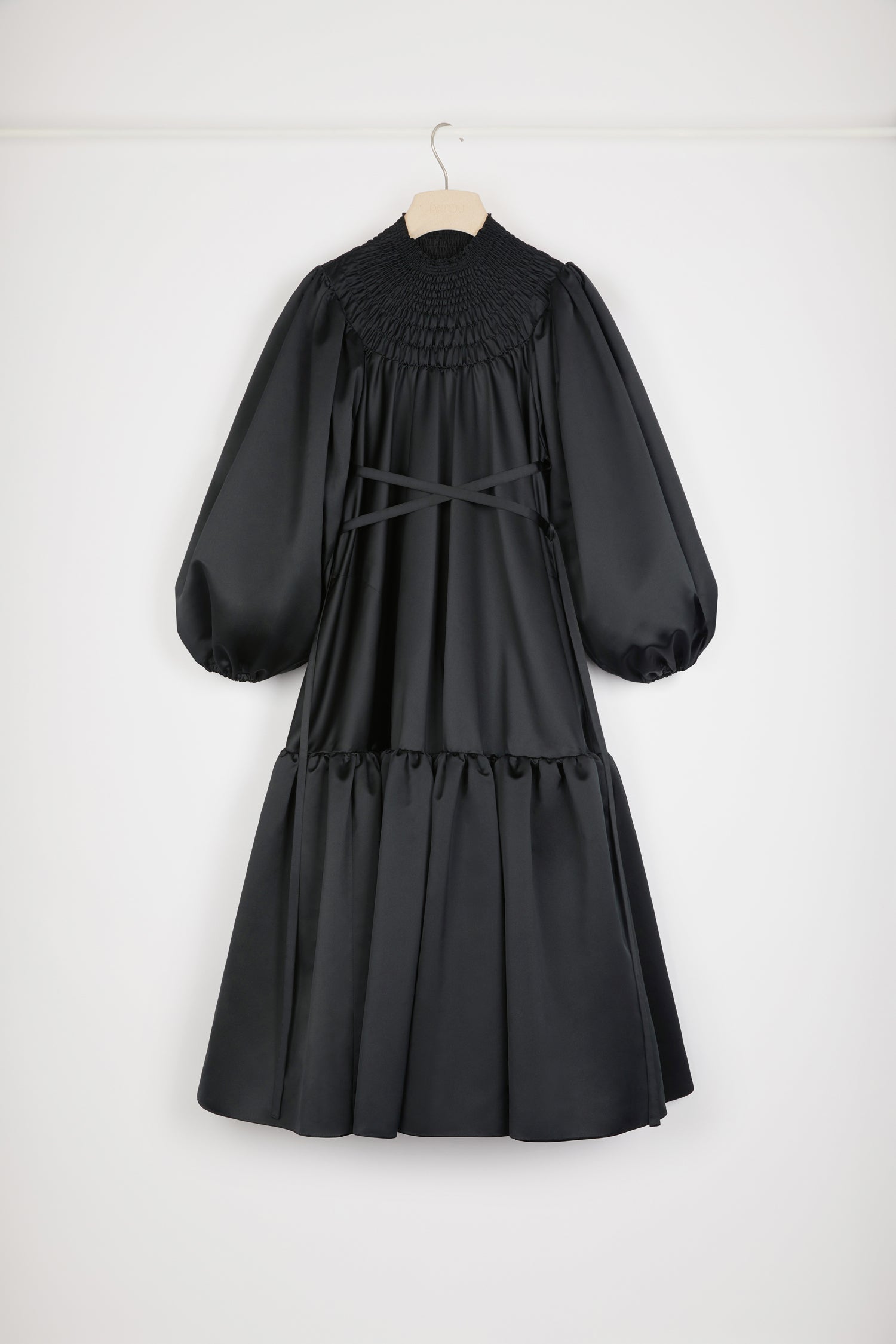 Patou - Smock collar maxi dress in eco-friendly satin - Black - This dress is a total smock show! Black recycled polyester satin dress. Maxi length. High neckline with smocked detailing. Volume sleeves with puff shoulders and elasticated cuffs. Removable belt at the waist that can be tied at the front or back. Tiered skirt.Voluminous dress with puffed sleeves.