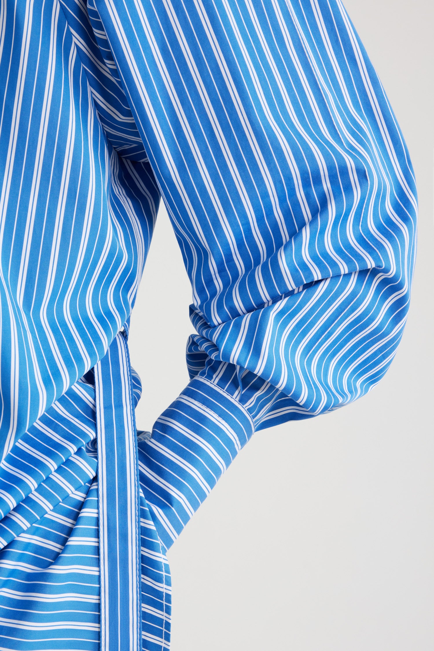 Patou - Mini shirt dress in printed sustainable cotton - Victoria Blue Stripes - Victoria Blue sustainable cotton poplin dress. Striped pattern. Short length. Straight silhouette. Shirt collar. JP-engraved mother-of-pearl buttons. Shoulder tabs. Volume raglan sleeves. Buttoned cuffs. Removable self-tie belt at the waist. Embroidered Patou and JP at the front.