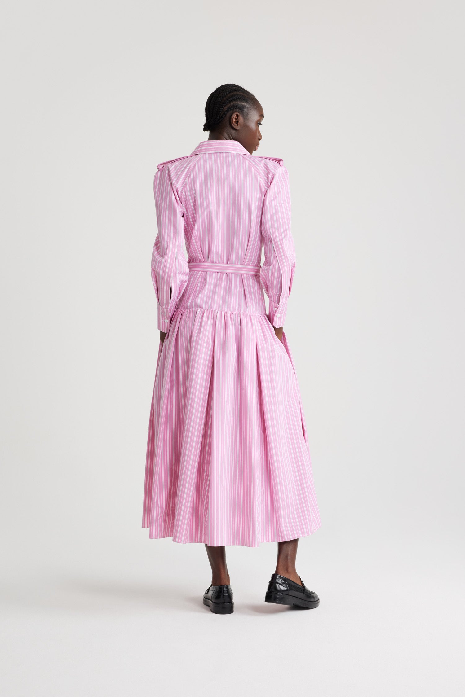 Patou - Maxi shirt dress in printed sustainable cotton - Pink Stripes - Pink sustainable cotton poplin dress. Striped pattern. Maxi length. Full volume tiered skirt. Shirt collar. JP-engraved mother-of-pearl buttons. Shoulder tabs. Raglan sleeves. Buttoned cuffs. Removable belt at the waist with gold-tone buckle.