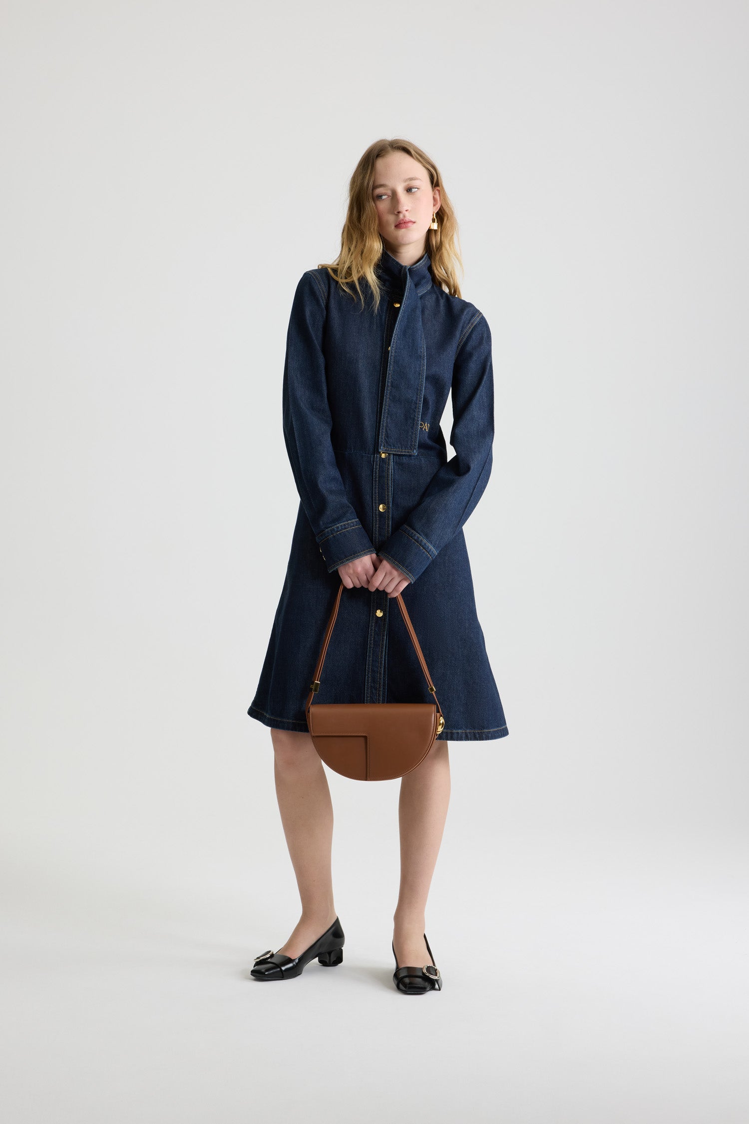 Patou - Scarf collar shirt dress in cotton blend denim - Blue Moon Rodeo - Blue Moon Rodeo cotton blend denim dress. Striped pattern. Knee length. Fit and flare silhouette. Scarf collar with loop at the front. Concealed button front fastening. Patou logo embroidered at the waist. Buttoned cuffs. Pockets at the sides.