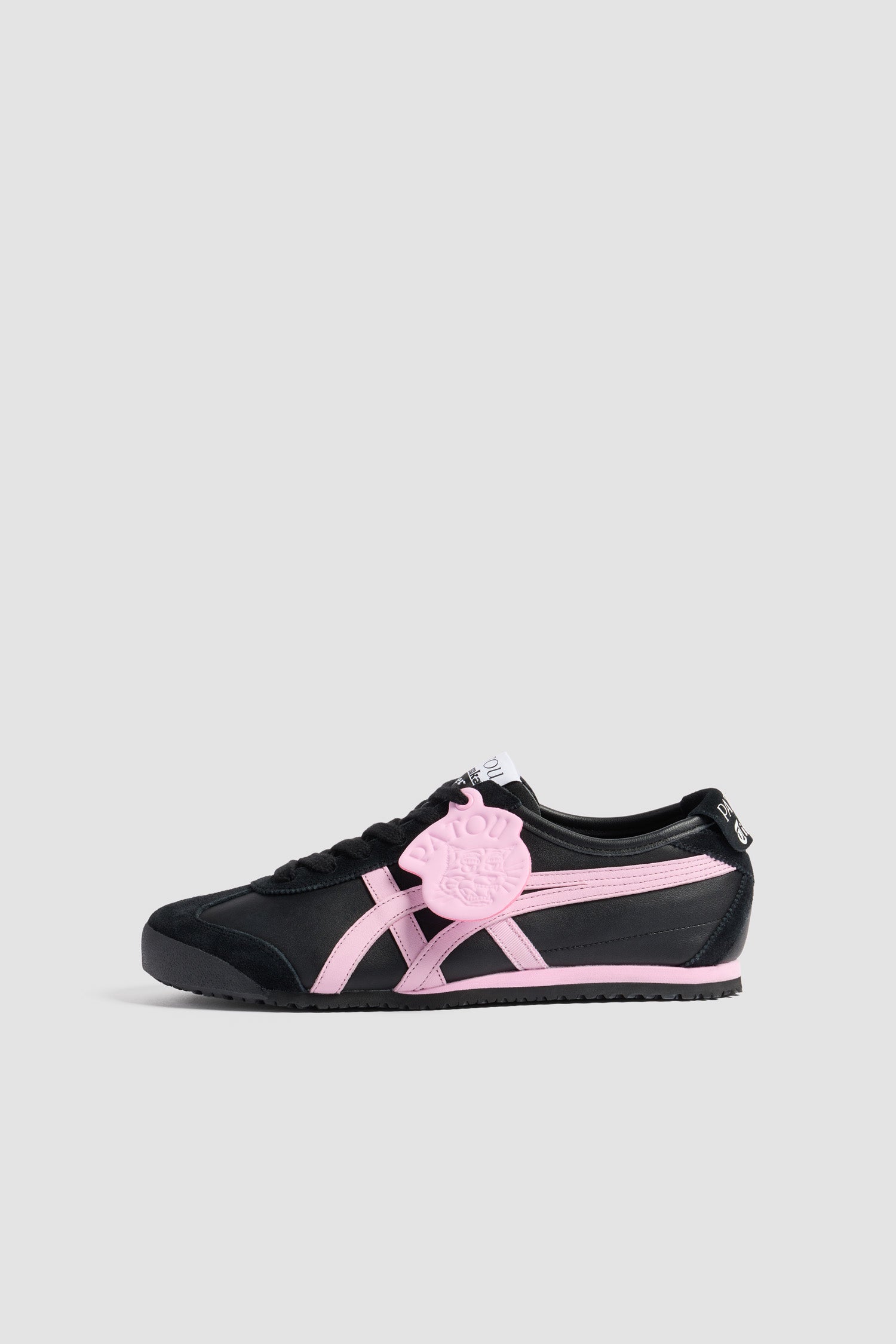 Patou - Patou x Onitsuka Tiger Mexico 66 trainers in nappa - Black - Black nappa trainers. Exclusive style from a special collaboration with Onitsuka Tiger. Iconic Mexico 66 design. Signature stripes in contrast leather and grosgrain. Contrast leather tag embossed with the Patou logo and Tiger motif. Patou and Tiger logos on the tongue and heel tab. Lace fastening. Two-tone rubber sole.