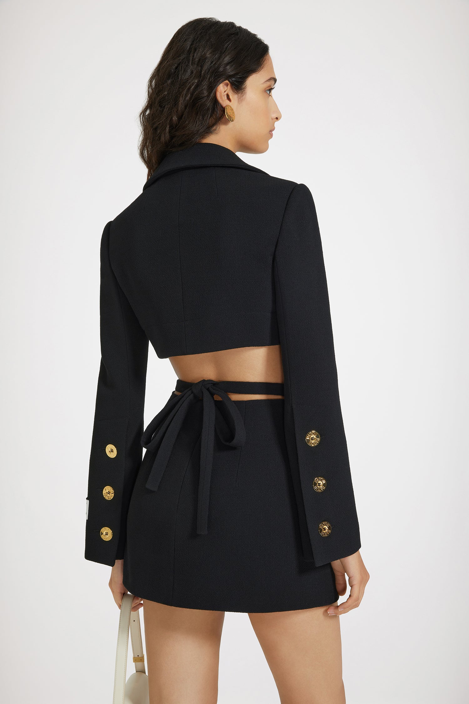 Patou - Cropped jacket in wool crepe - Black - Very cropped, instantly iconic.Black double wool crepe jacket. Cropped length. Tailored silhouette. Notch lapels. Flap chest pockets. Gold-tone Patou-engraved buttons. Buttoned cuffs. Patou label on the left sleeve. Lined.This style is cropped.