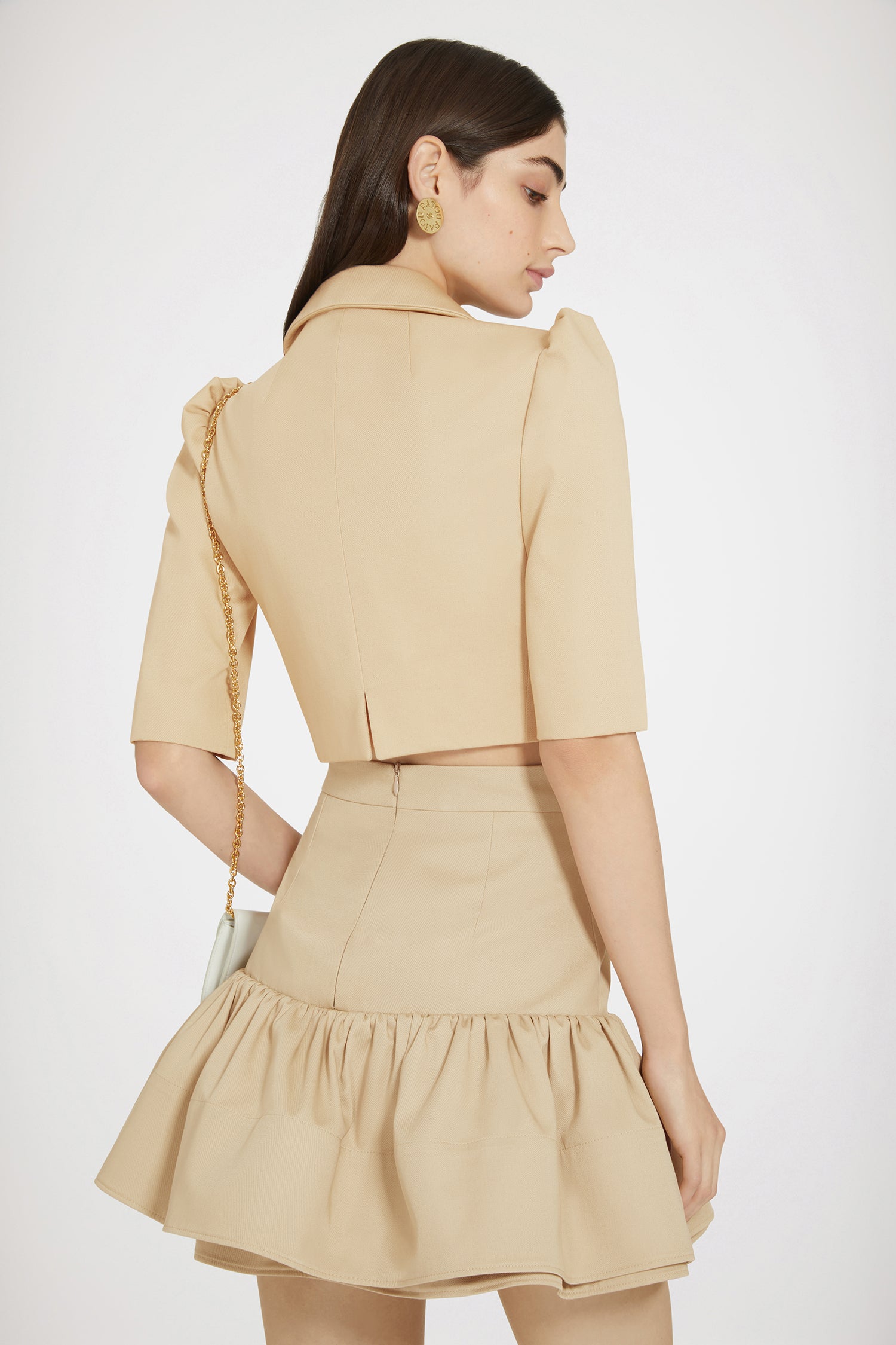 Patou - Cropped jacket in cotton gabardine - Beige - Puff shoulders make summer tailoring a little chicer.Beige cotton gabardine jacket. Cropped length. Tailored silhouette. Notch lapels. Puff shoulders. Flap chest pockets. Gold-tone Patou-engraved buttons.This cropped and highly fitted style is best worn with a tank top or equivalent.