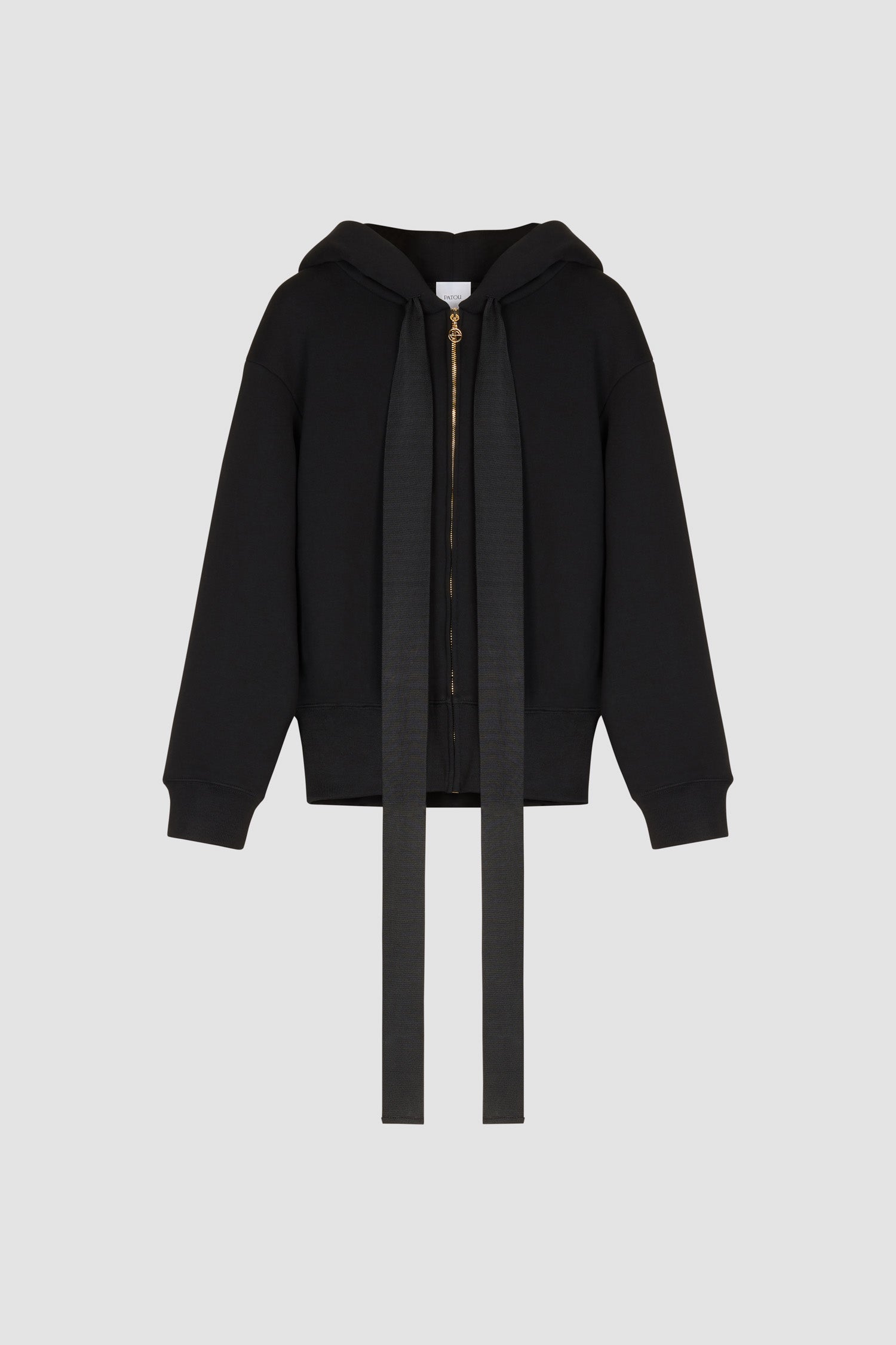 Patou - Organic cotton Patou zip-up hoodie - Black - The girl with the Patou hoodie.Black organic cotton zip up hoodie. Exaggerated grosgrain ties designed to hang loose at the front. Gold-coloured zip with stylised logo pull tab. Lettering logo in white at the back. Ribbed cuffs and waistband.