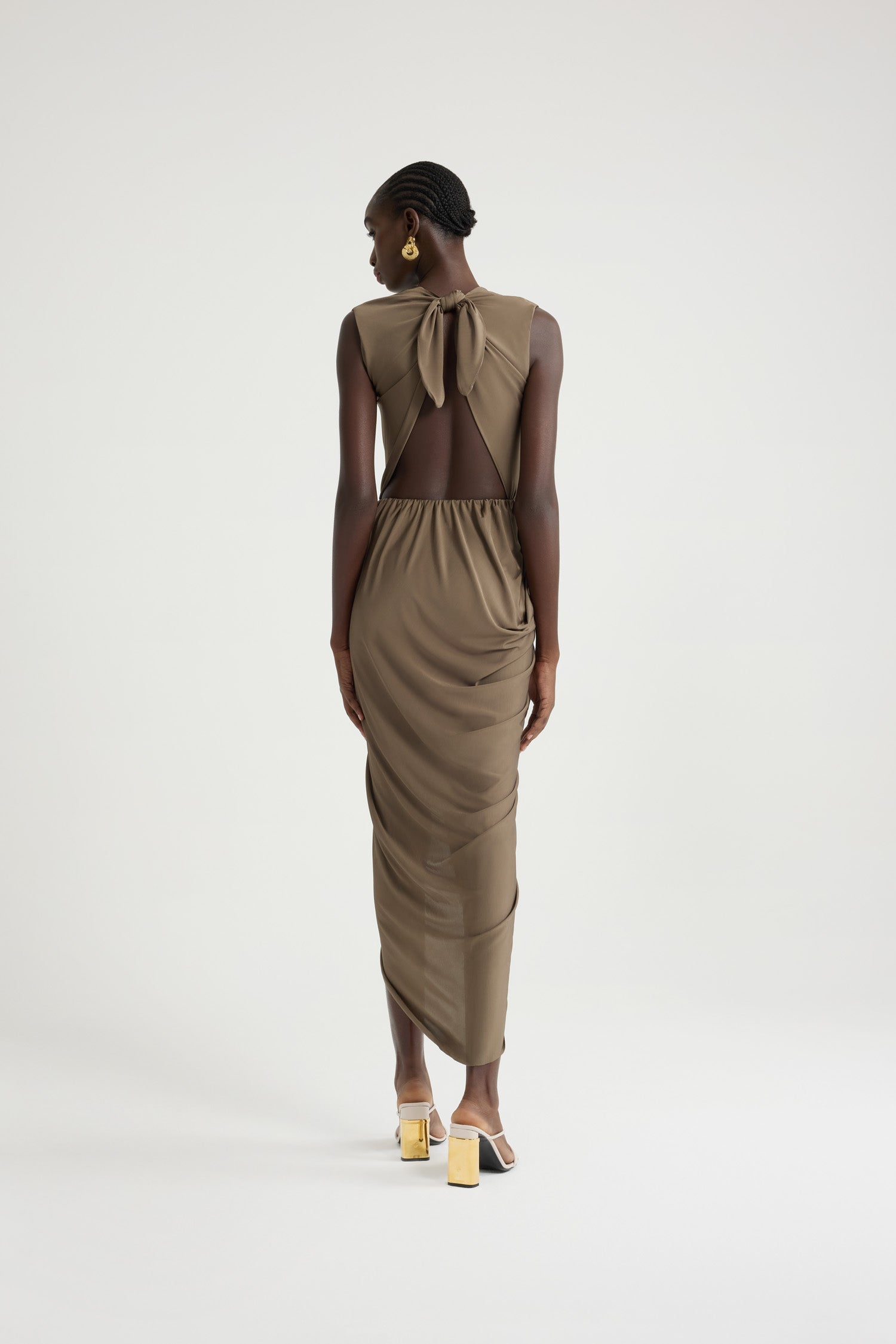 Patou - Open back dress in stretch jersey - Mocha - Mocha light brown stretch jersey dress. Midi length. Open back with knot fastening at the top. Elasticated waist. Draped wrap skirt with opening at the front. This style is very fitted.