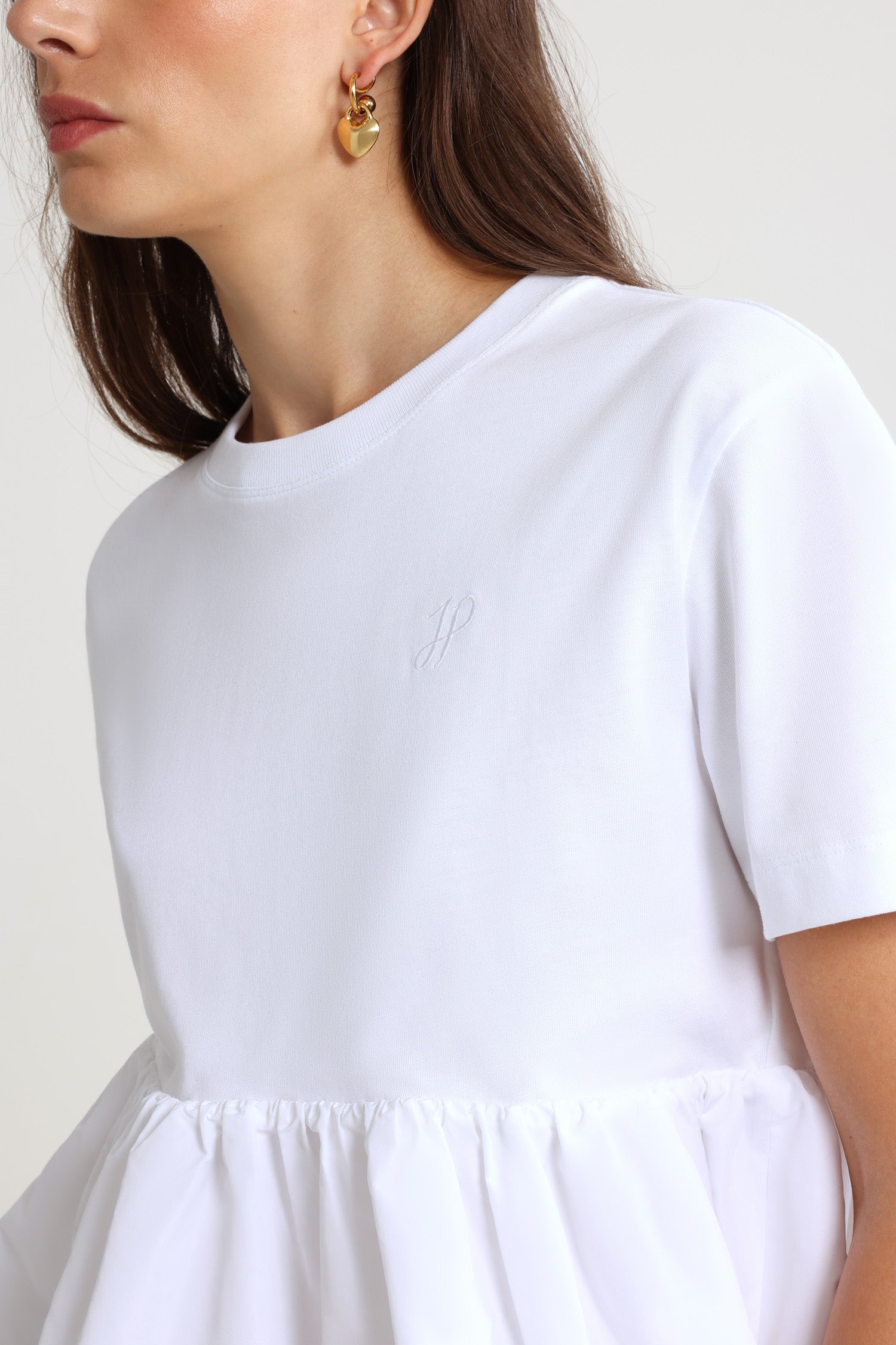 Patou - Ruffle hem t-shirt in organic cotton and faille - White - White organic cotton t-shirt. Thick jersey. Mixed media design with a contrast faille hem. Crewneck. Embroidered JP calligraphy monogram at the chest. Ruching at the waist.