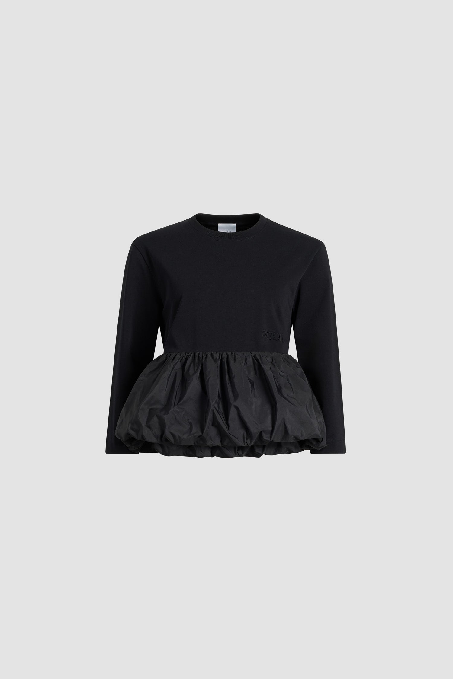 Patou - Ruffle hem t-shirt in organic cotton and faille - Black - Black organic cotton t-shirt. Thick jersey. Peplum silhouette with a polyester faille ruffle. Crewneck. Embroidered Patou logo at the front.