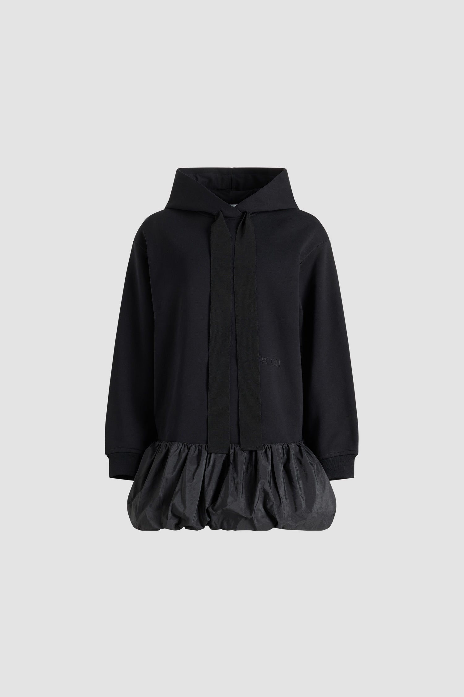 Patou - Ruffle hem hoodie dress in organic cotton and faille - Black - Black organic cotton hoodie. Contrast hem with a polyester faille ruffle. Hooded collar with grosgrain drawstring. Embroidered Patou logo at the front. Ribbed cuffs.