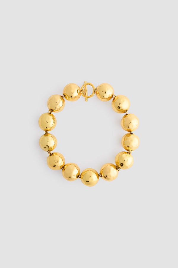 Patou - Collier à boules martelées en laiton doré - Gold - Collier en laiton doré. Boules martelées. Patou gravé. Fermoir en T.