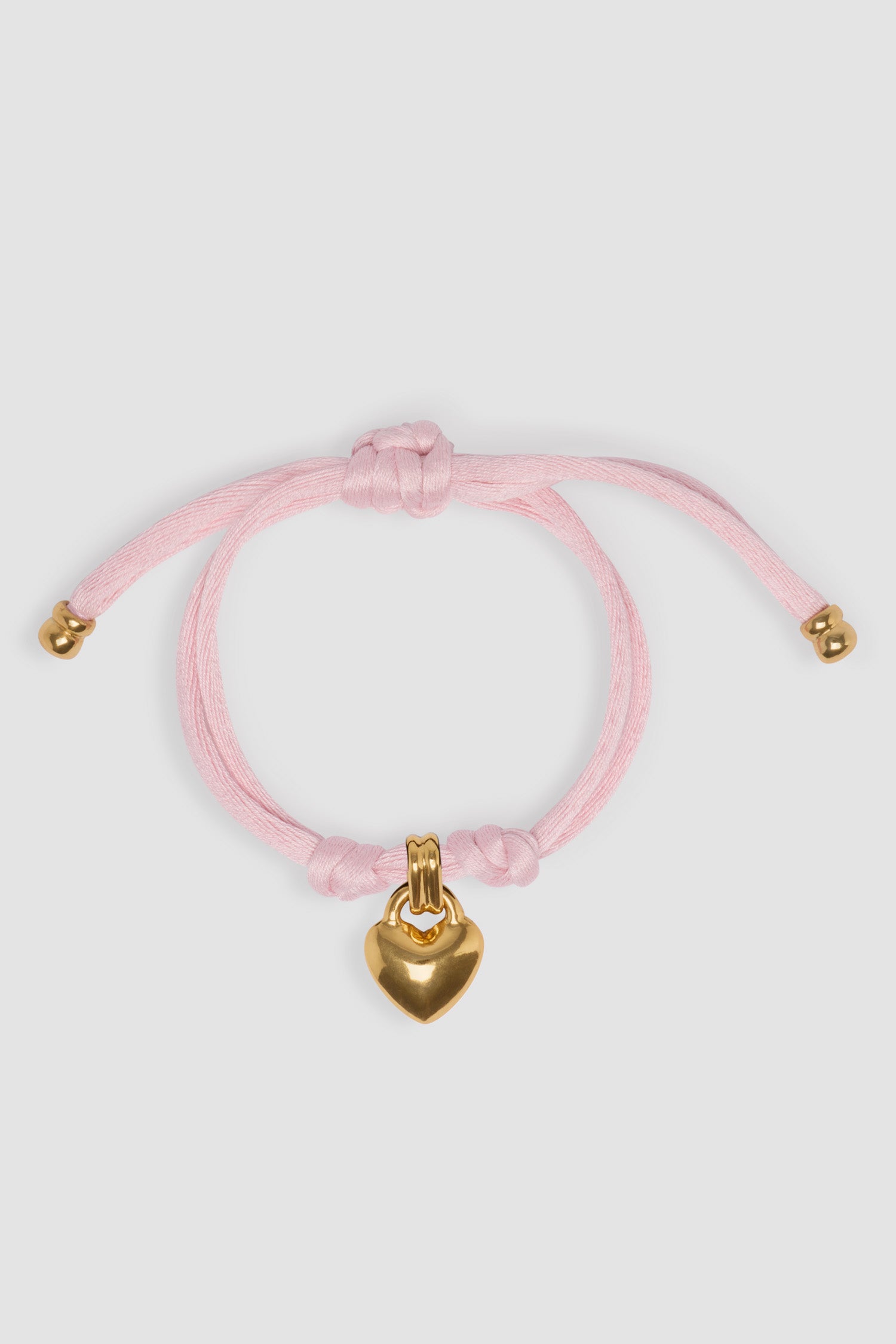 Patou - Heart bracelet in gold-plated brass and cotton - Primrose Pink - Gold-plated brass and Primrose Pink cotton bracelet. Heart charm. Double cord with gold-plated brass tips.