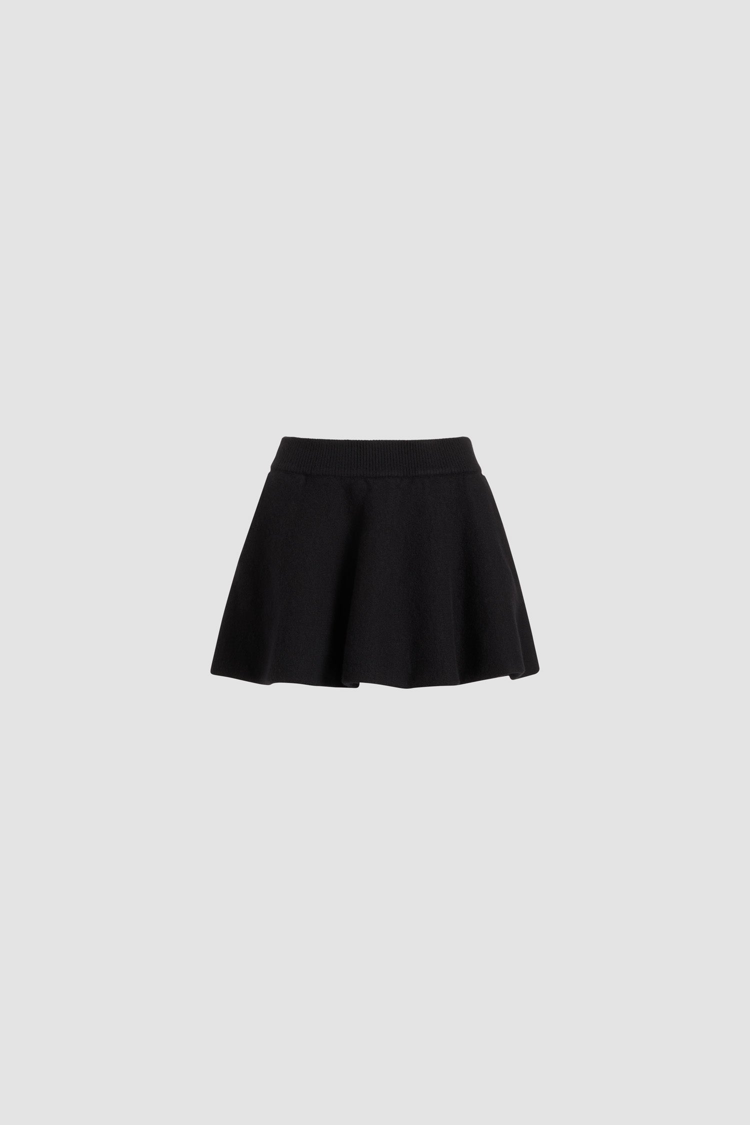 Patou - A-line mini skirt in wool - Black - Black Merino wool skirt. Short length. A-line silhouette with soft pleats. Ribbed elasticated waist.