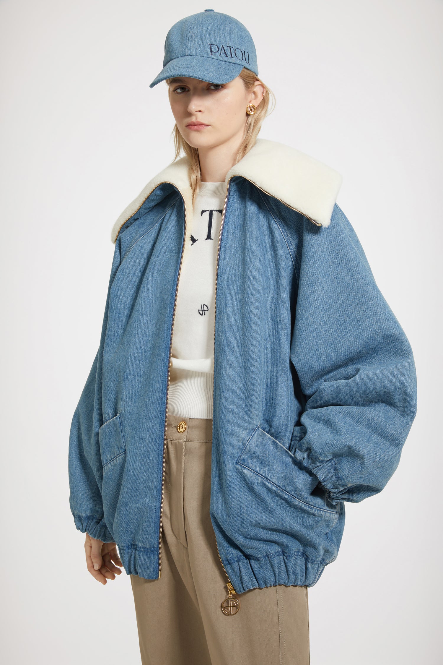 Patou - Oversized jacket in organic cotton denim and faux shearling - Ice Blue - Chez Patou, sherpas are making a comeback!Ice Blue organic cotton denim jacket. Sustainable laser fading. Sherpa-inspired design with faux shearling lining. Oversized cocoon silhouette. Exaggerated collar. Gold-tone zip fastening with signature JP puller. Raglan sleeves. Wide diagonal welt pockets. Elasticated cuffs and hem. Embroidered Patou logo at the back.Oversize style (select one size down for a fitted look).