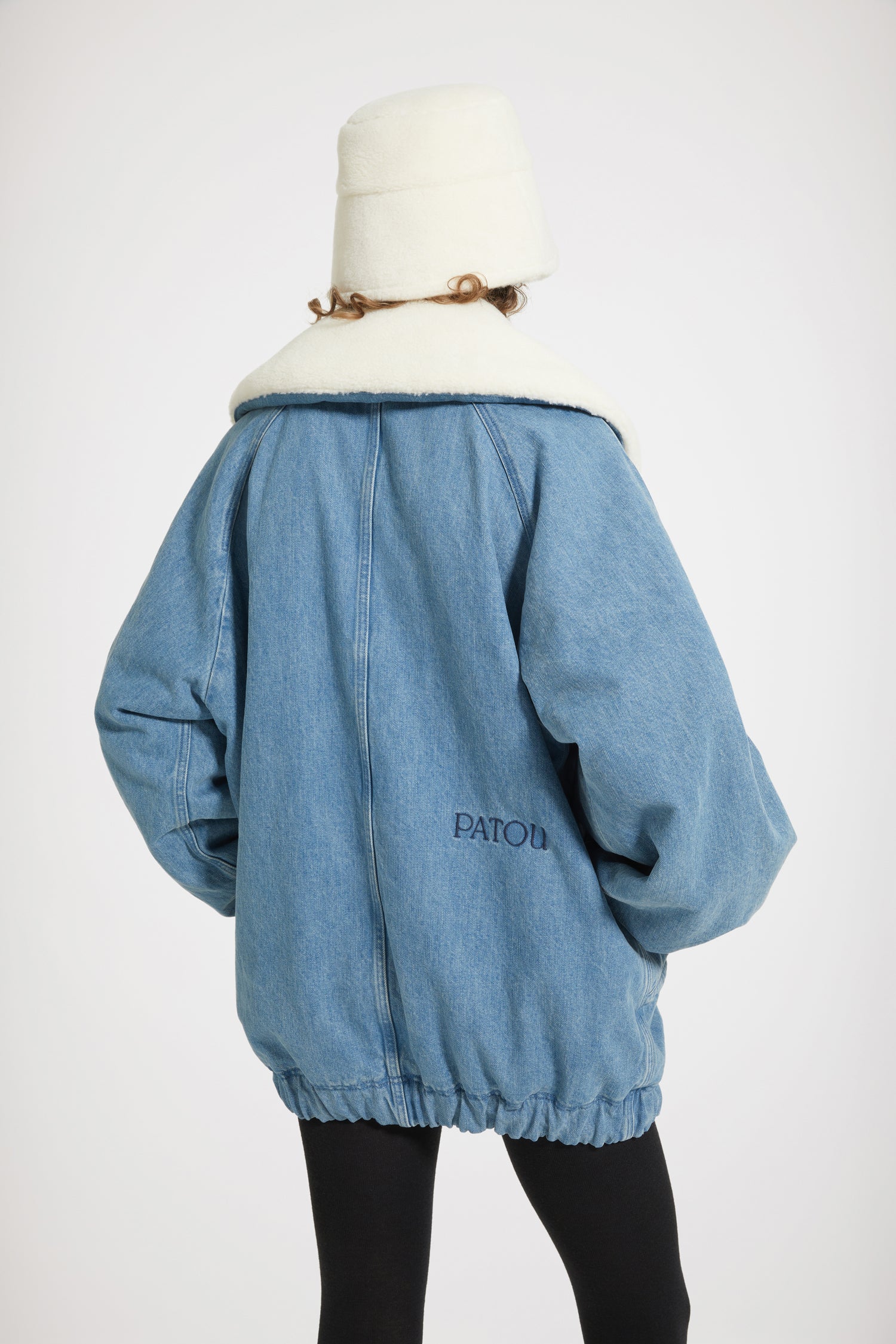 Patou - Oversized jacket in organic cotton denim and faux shearling - Ice Blue - Chez Patou, sherpas are making a comeback!Ice Blue organic cotton denim jacket. Sustainable laser fading. Sherpa-inspired design with faux shearling lining. Oversized cocoon silhouette. Exaggerated collar. Gold-tone zip fastening with signature JP puller. Raglan sleeves. Wide diagonal welt pockets. Elasticated cuffs and hem. Embroidered Patou logo at the back.Oversize style (select one size down for a fitted look).