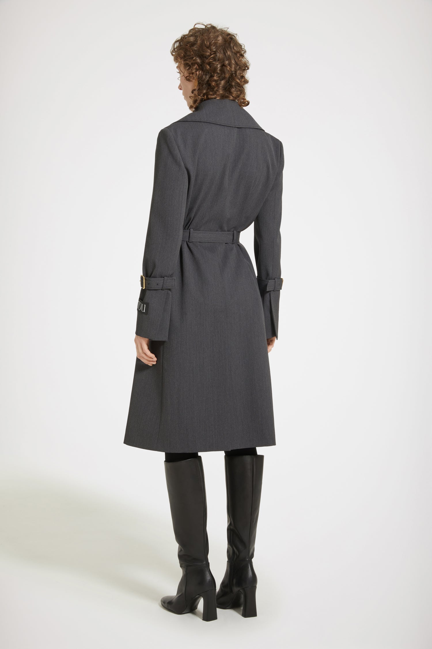 Patou - Trench coat in technical wool twill - Anthracite - The trench goes French.Anthracite grey technical wool twill trench coat. Tailored single-breasted silhouette. Knee length. Notch lapels. Storm flap at the front. Gold-tone Patou-engraved buttons at the front. Adjustable gold-tone buckle belt that sits at the waist. Side seam patch pockets at the front. Belted cuffs. Signature Patou label on the left arm. Signature curved seam at the back. Single back vent with gold-tone Patou-engraved button.